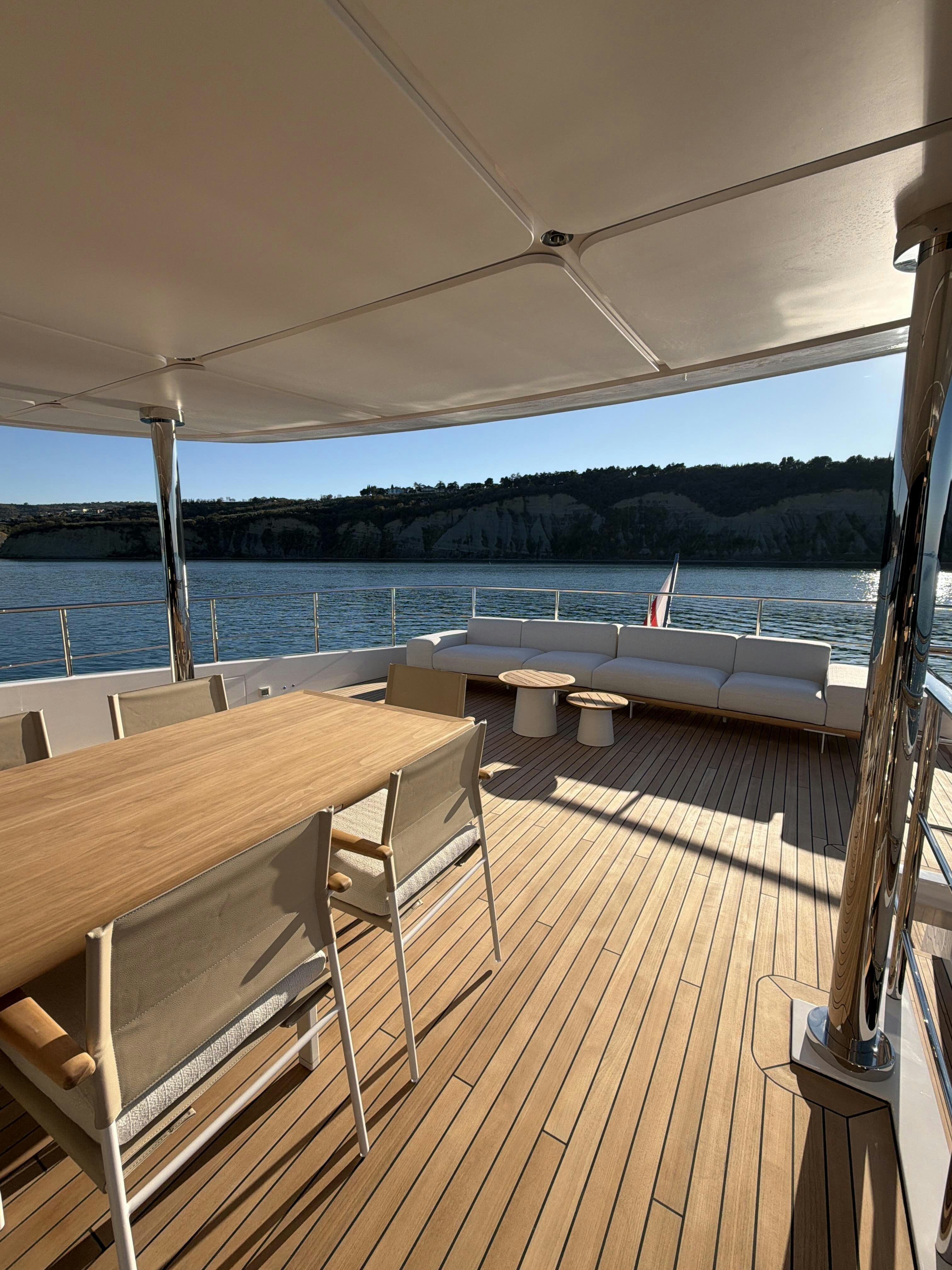 a table and chairs on a deck aboard LA VETTA Yacht for Sale