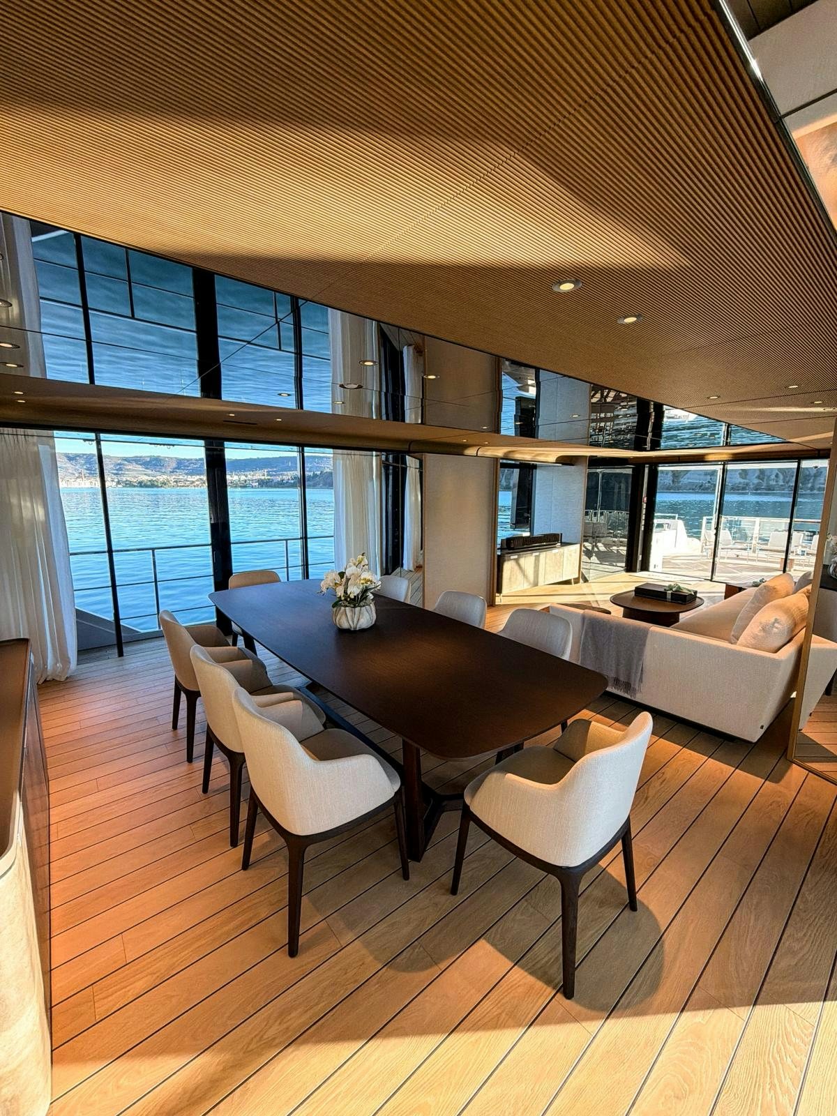 a room with a table and chairs aboard LA VETTA Yacht for Sale