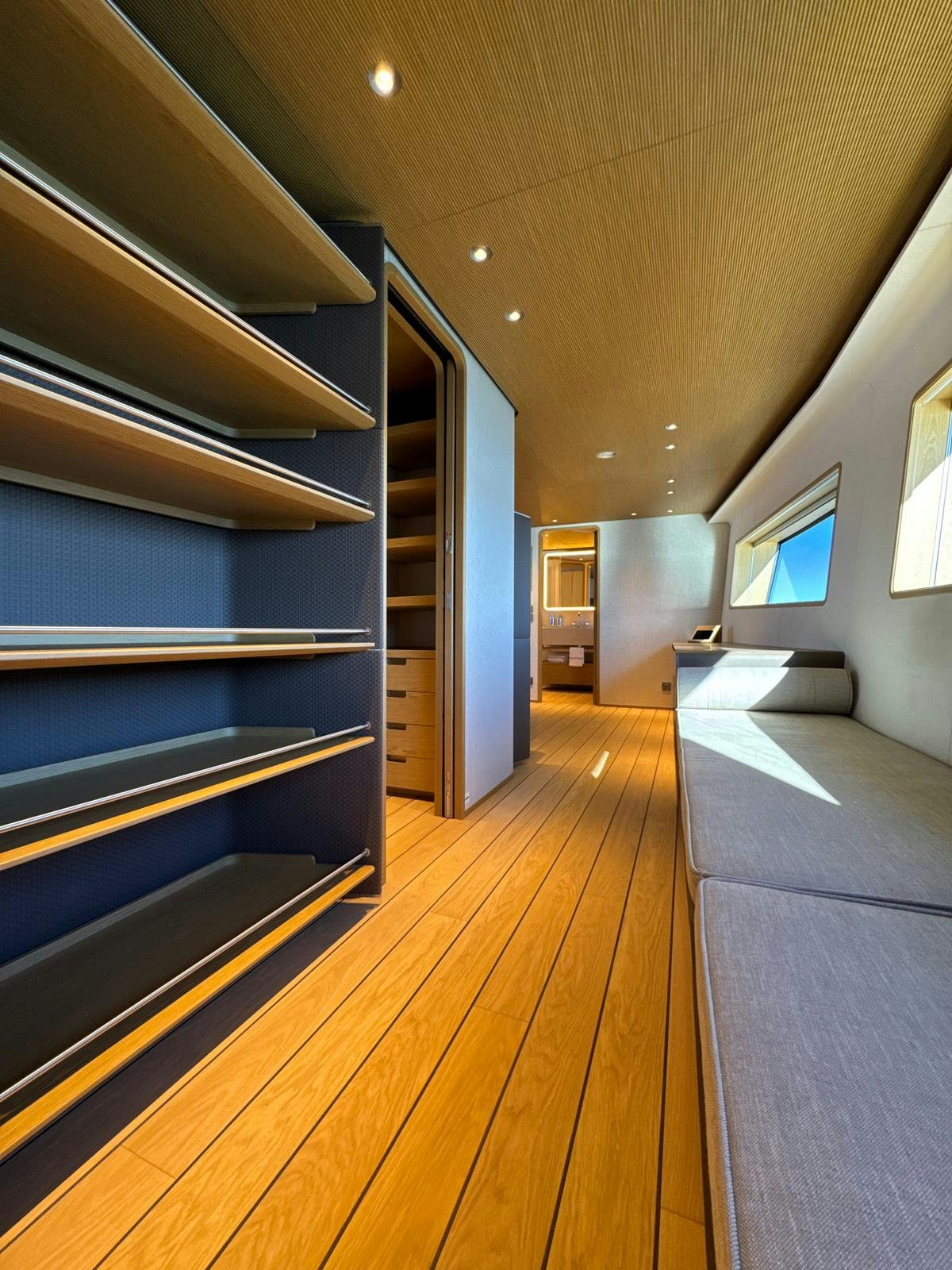 a room with a wood floor and a wood floor and a blue cabinet aboard LA VETTA Yacht for Sale