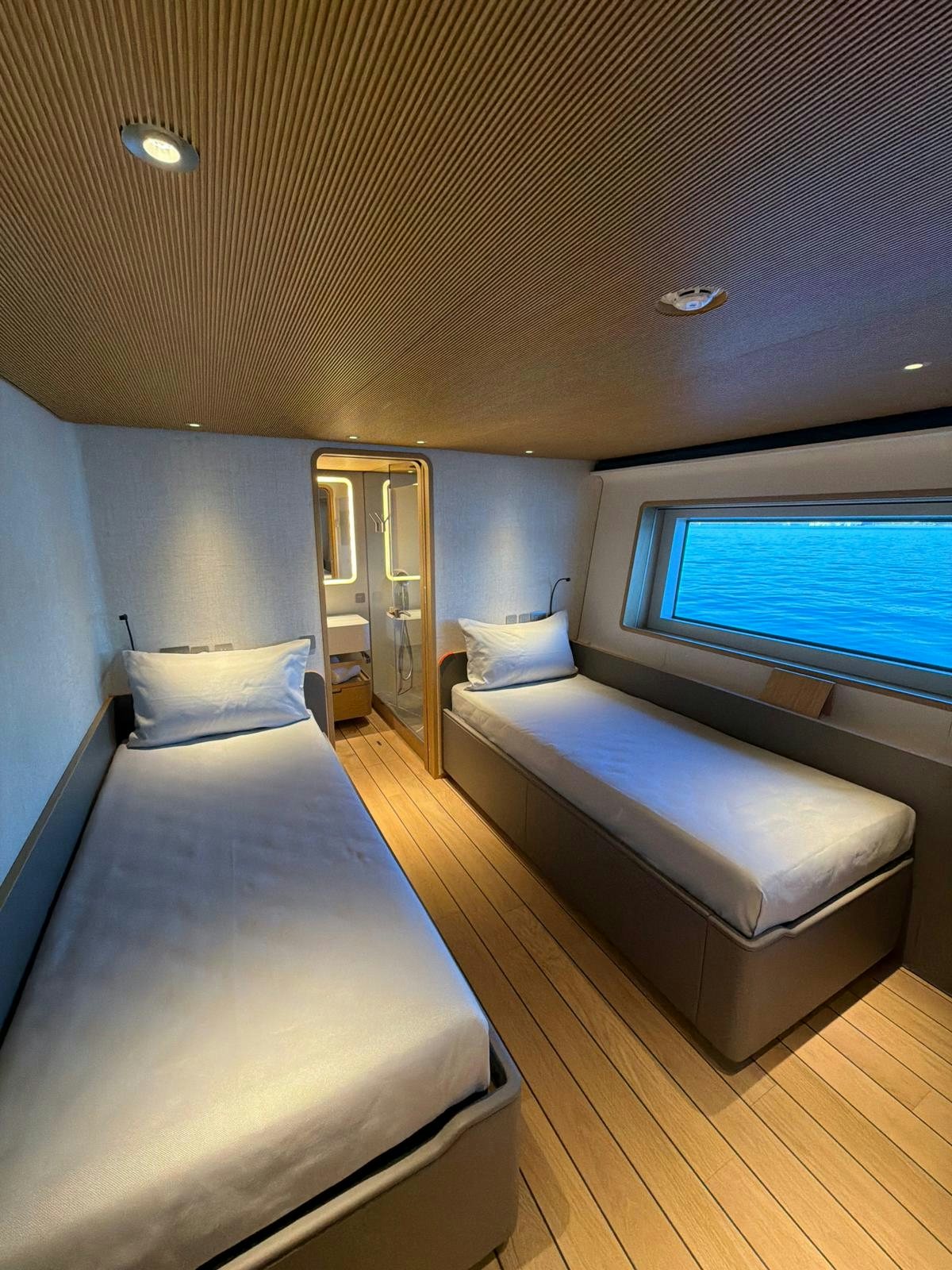 a room with a bed and a window aboard LA VETTA Yacht for Sale
