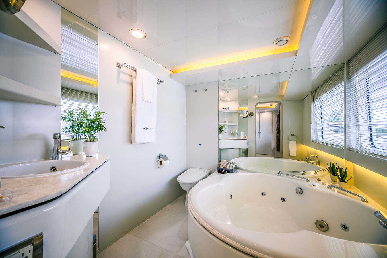 a bathroom with a tub sink and a toilet aboard KARTAL YUVASI Yacht for Charter
