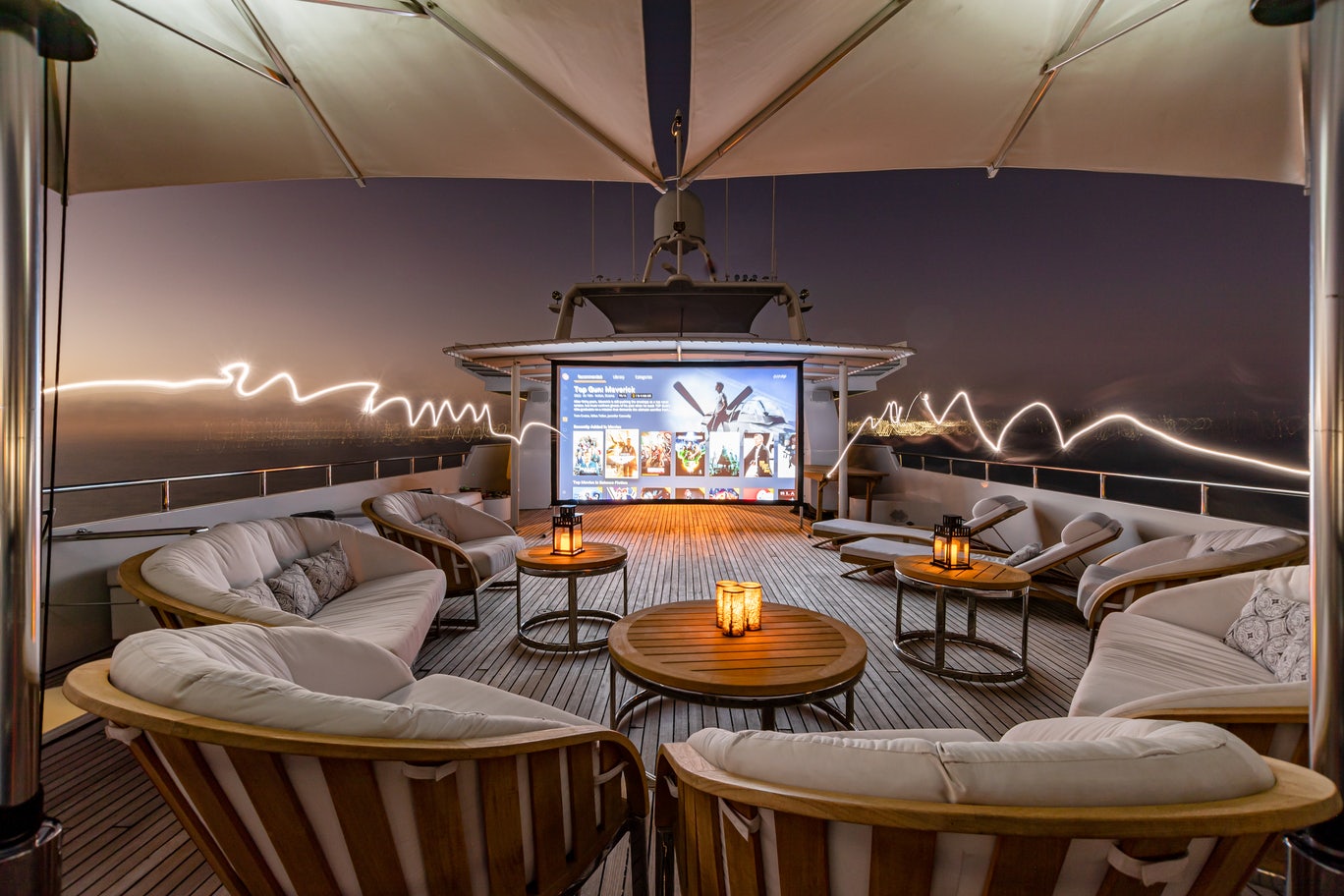 a living room with a large screen aboard KARTAL YUVASI Yacht for Charter