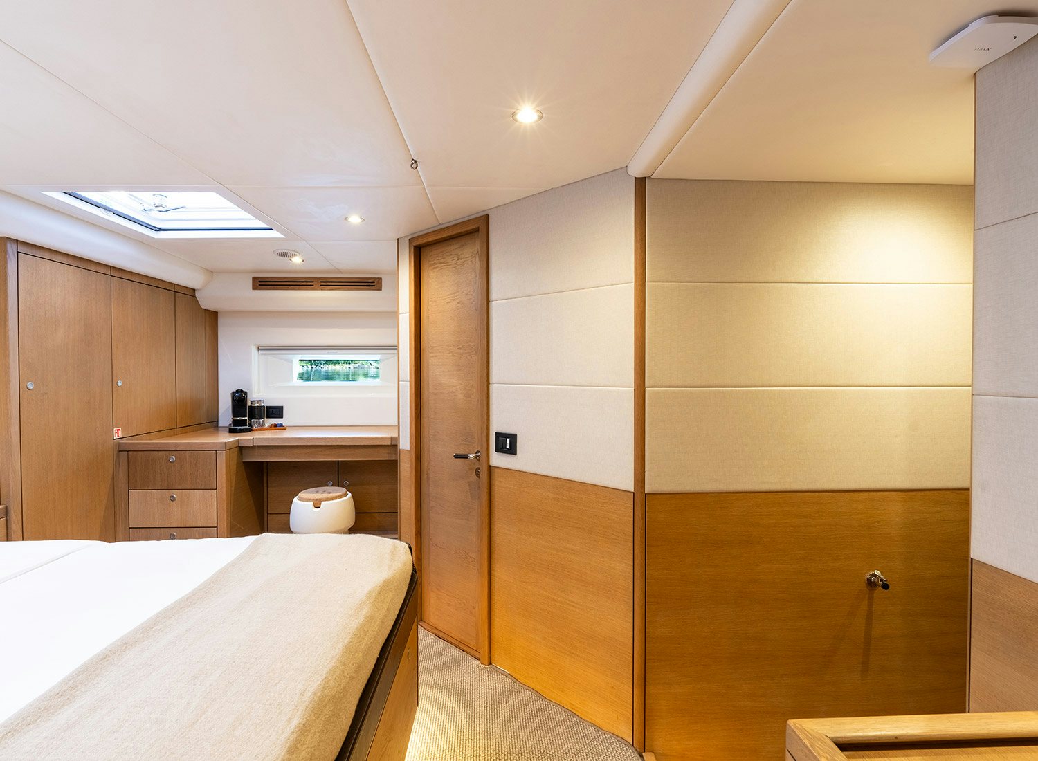a room with a bed and a desk aboard CHAMPAGNE HIPPY Yacht for Sale