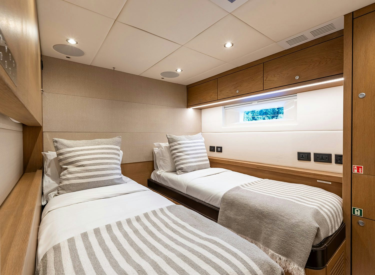 a room with beds and a tv aboard CHAMPAGNE HIPPY Yacht for Sale