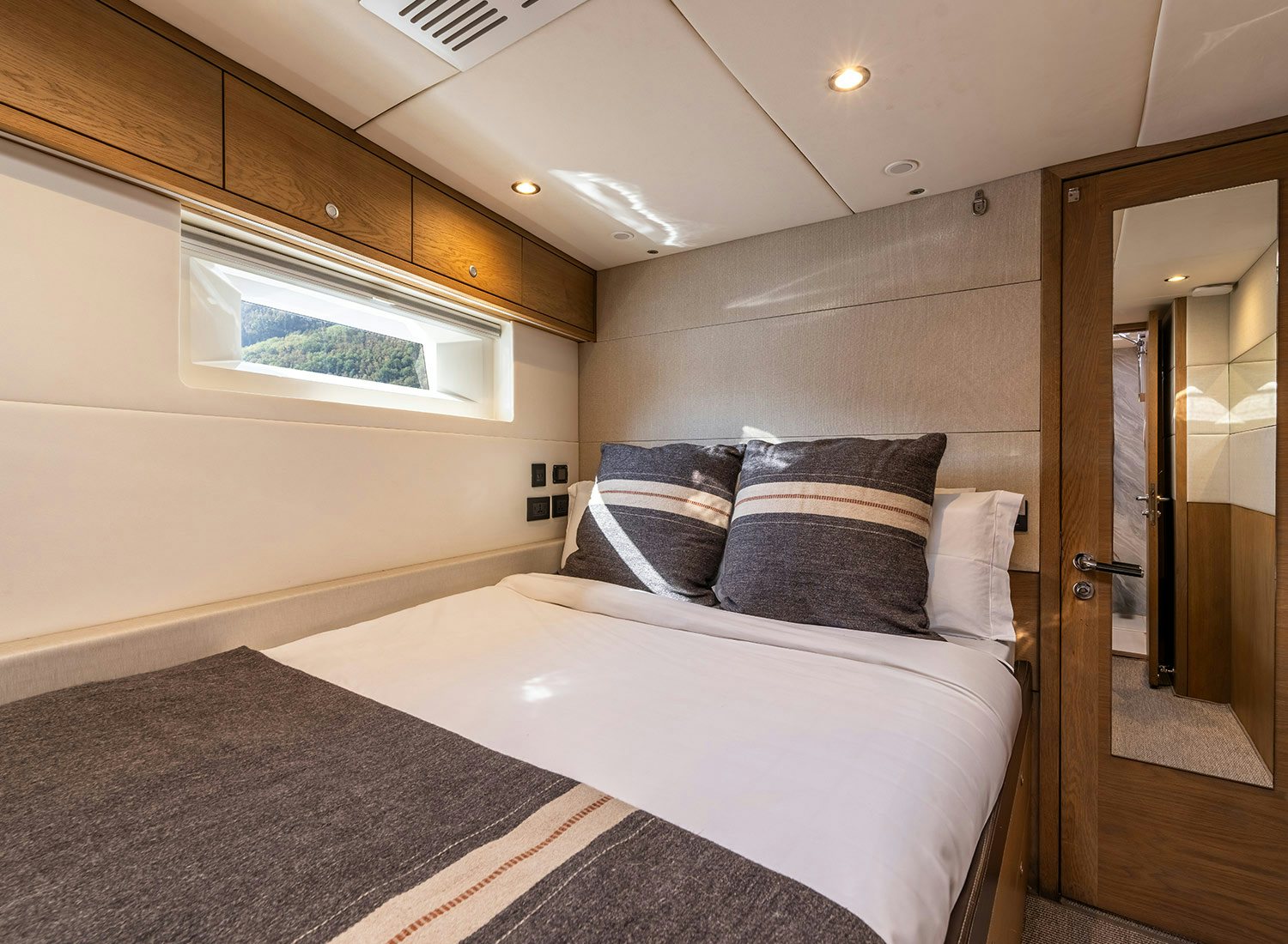 a bed with pillows aboard CHAMPAGNE HIPPY Yacht for Sale