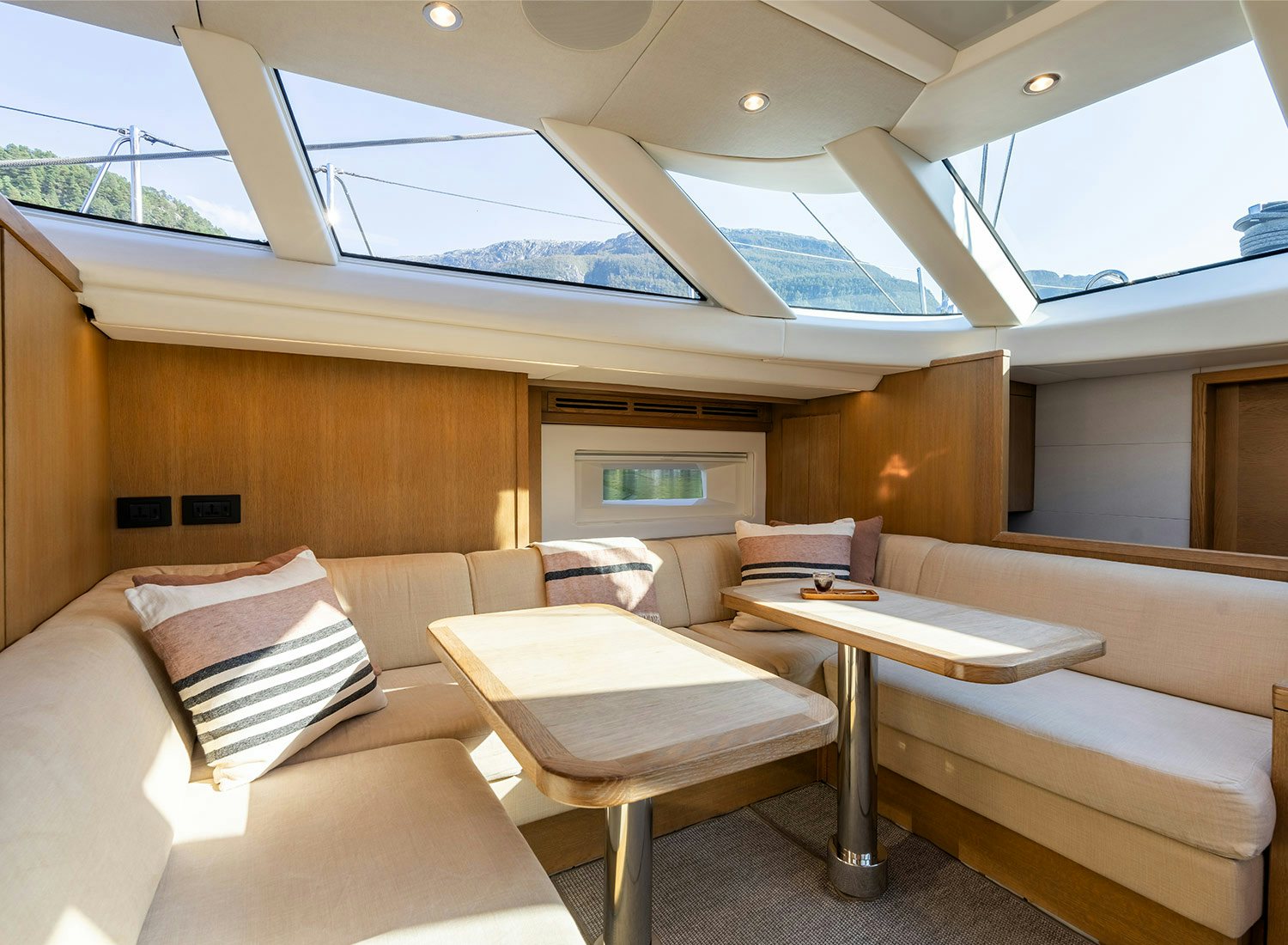 a room with a table and couch aboard CHAMPAGNE HIPPY Yacht for Sale