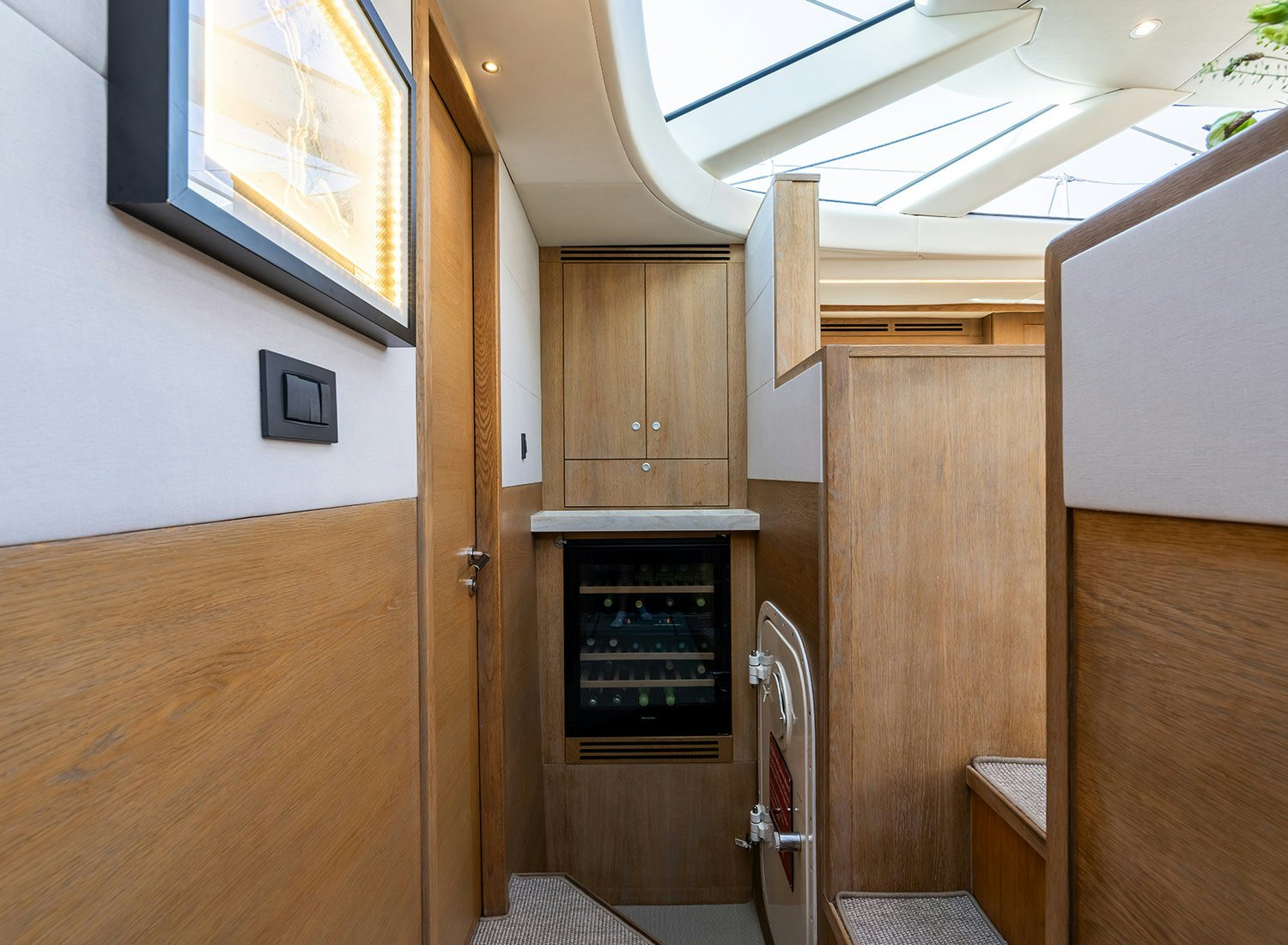 a room with a fireplace and wood cabinets aboard CHAMPAGNE HIPPY Yacht for Sale