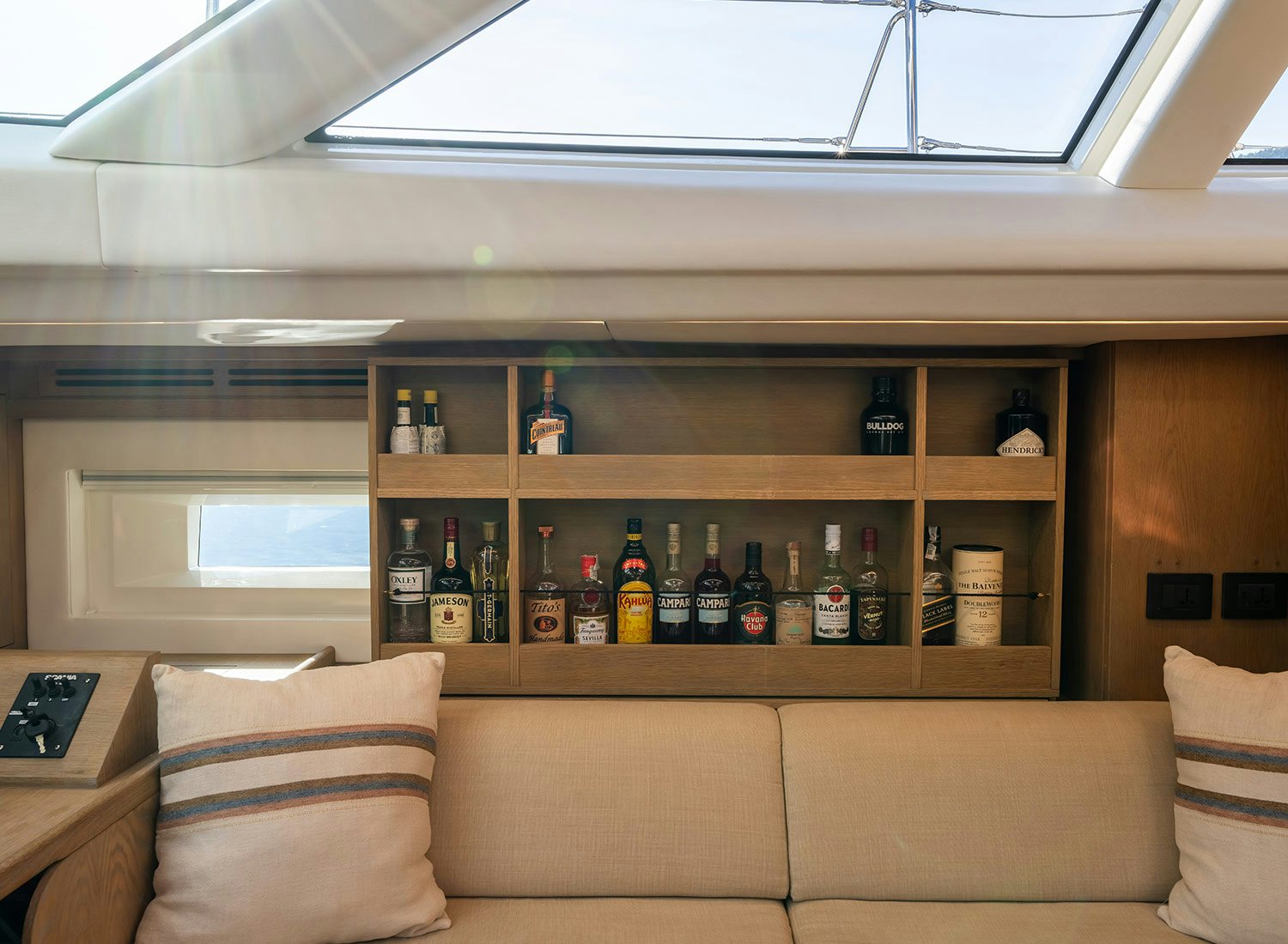 a couch with bottles on it aboard CHAMPAGNE HIPPY Yacht for Sale