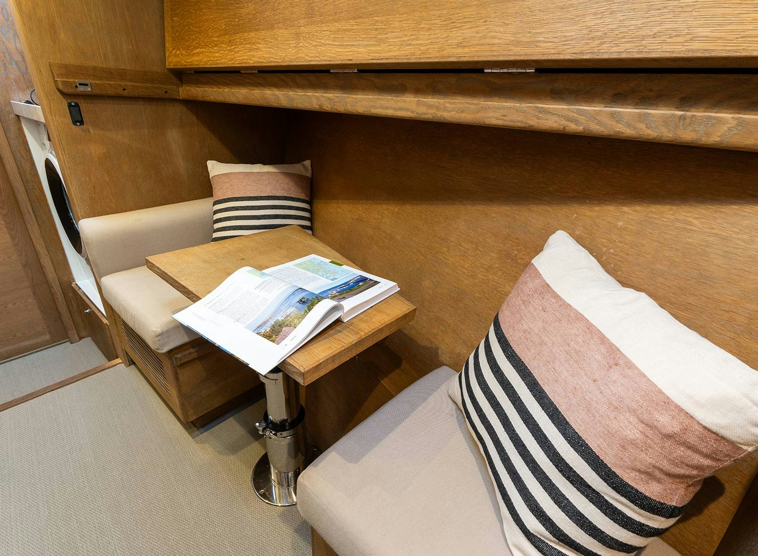 a couch with a coffee table and a chair aboard CHAMPAGNE HIPPY Yacht for Sale