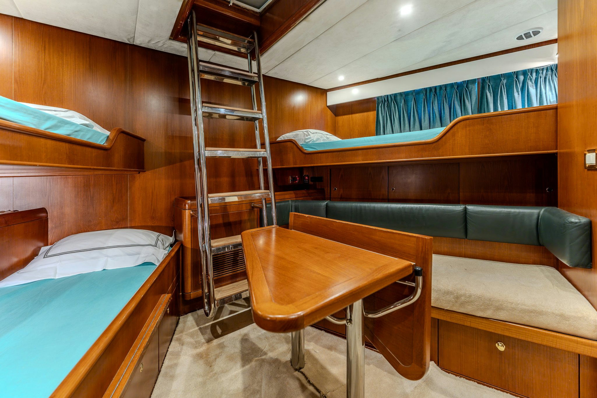 a bunk bed and a couch in a cabin aboard YOSMA Yacht for Sale