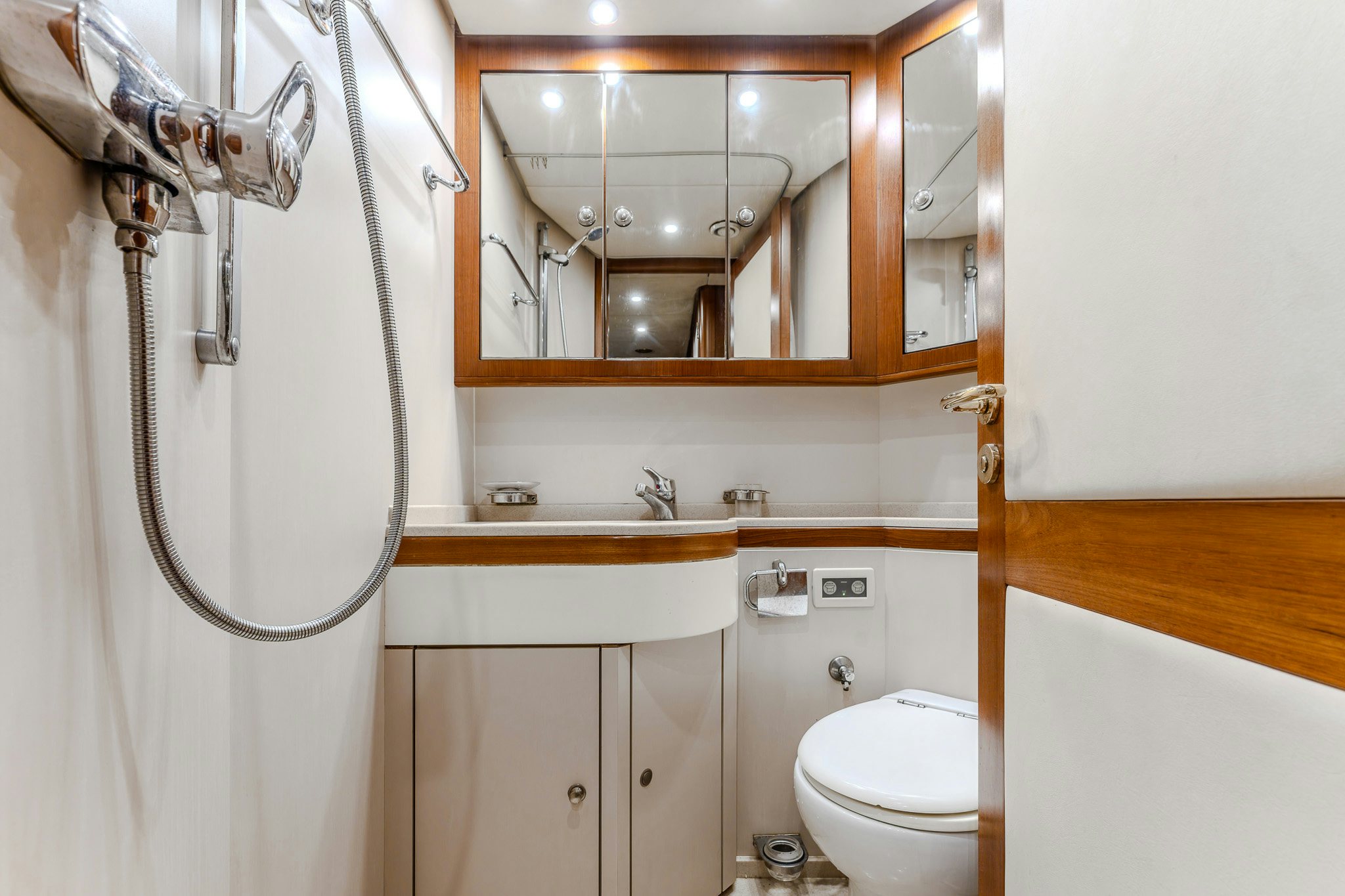 a bathroom with a mirror and a toilet aboard YOSMA Yacht for Sale