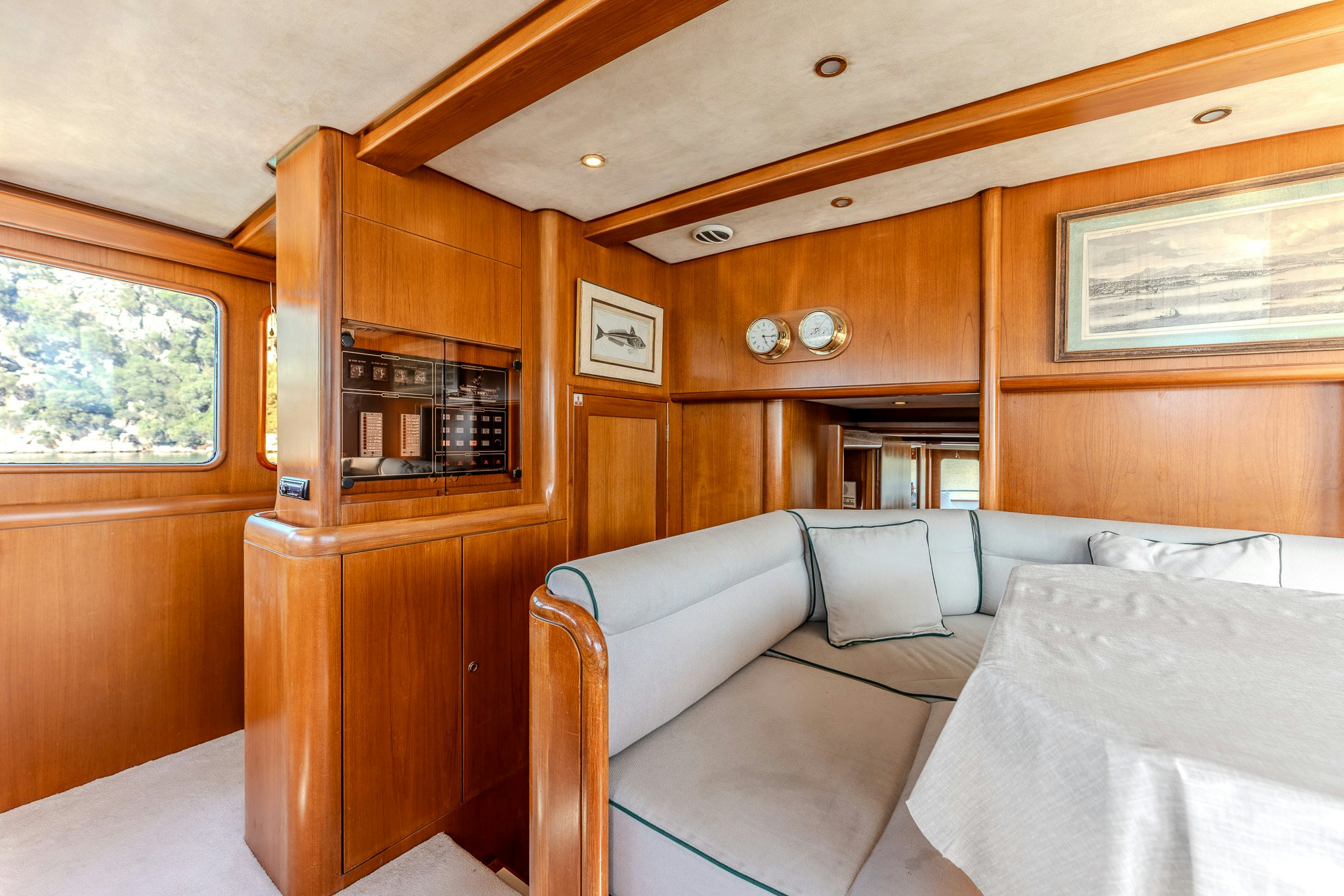 a living room with a couch and a wood cabinet aboard YOSMA Yacht for Sale