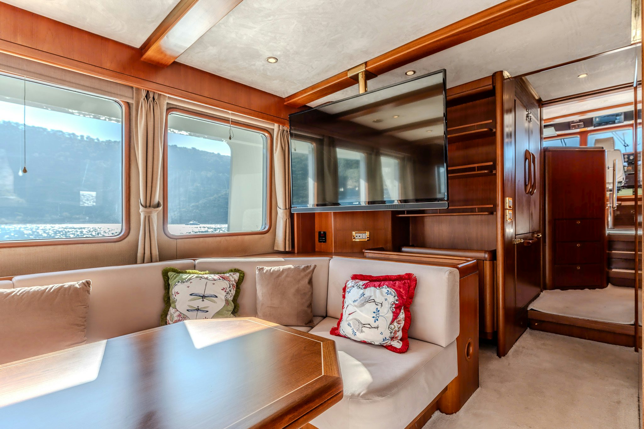 a living room with a couch and a table aboard YOSMA Yacht for Sale