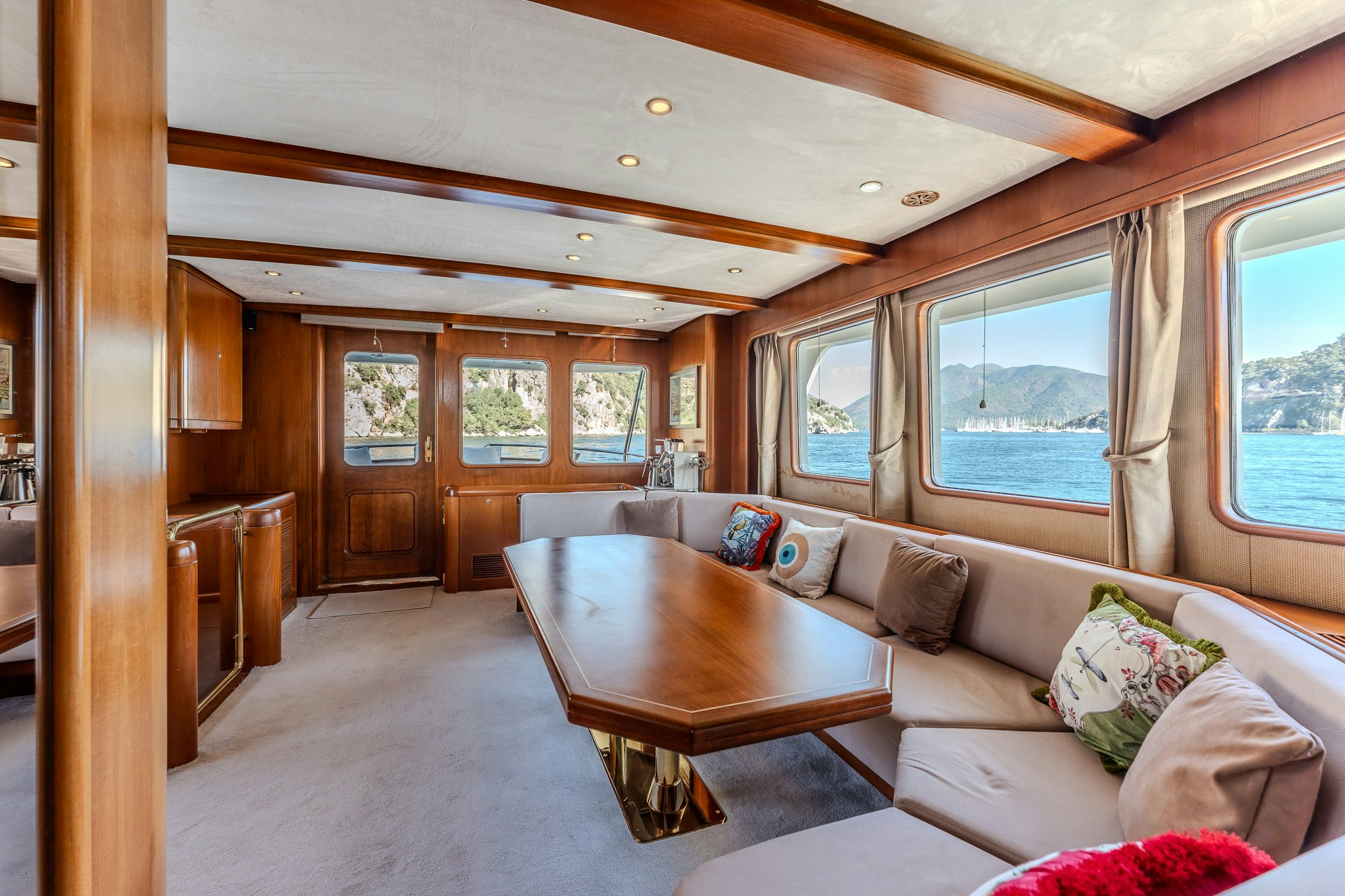 a living room with a couch and a table aboard YOSMA Yacht for Sale