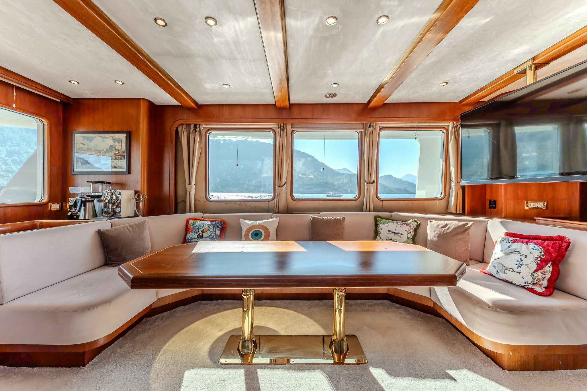 a living room with a large table aboard YOSMA Yacht for Sale