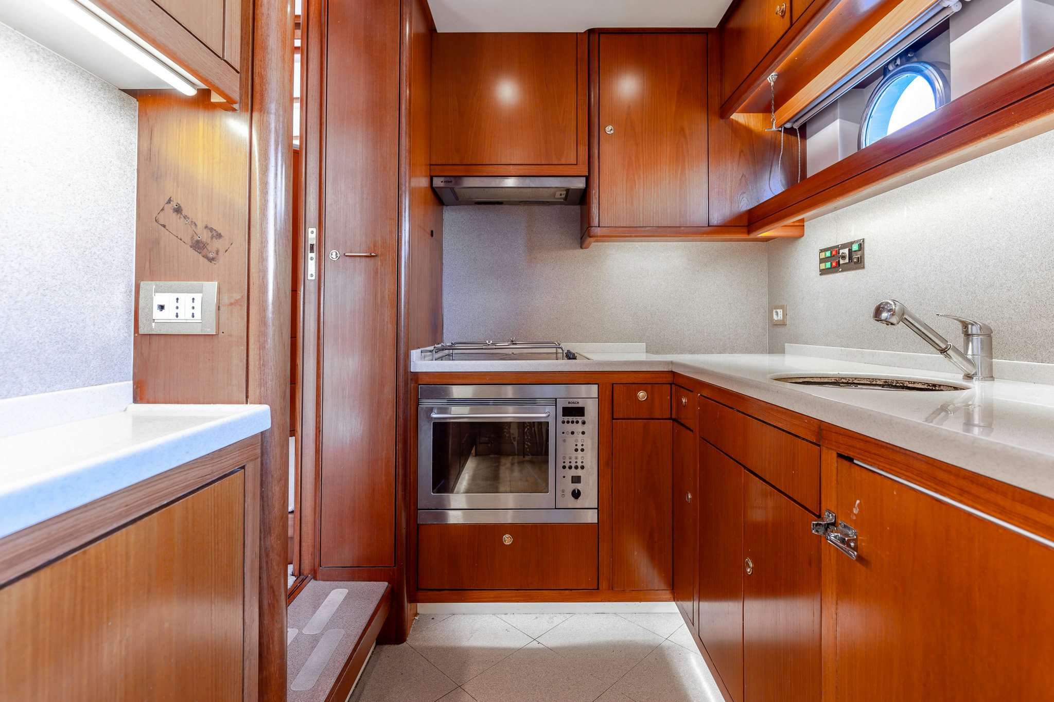 a kitchen with wooden cabinets aboard YOSMA Yacht for Sale