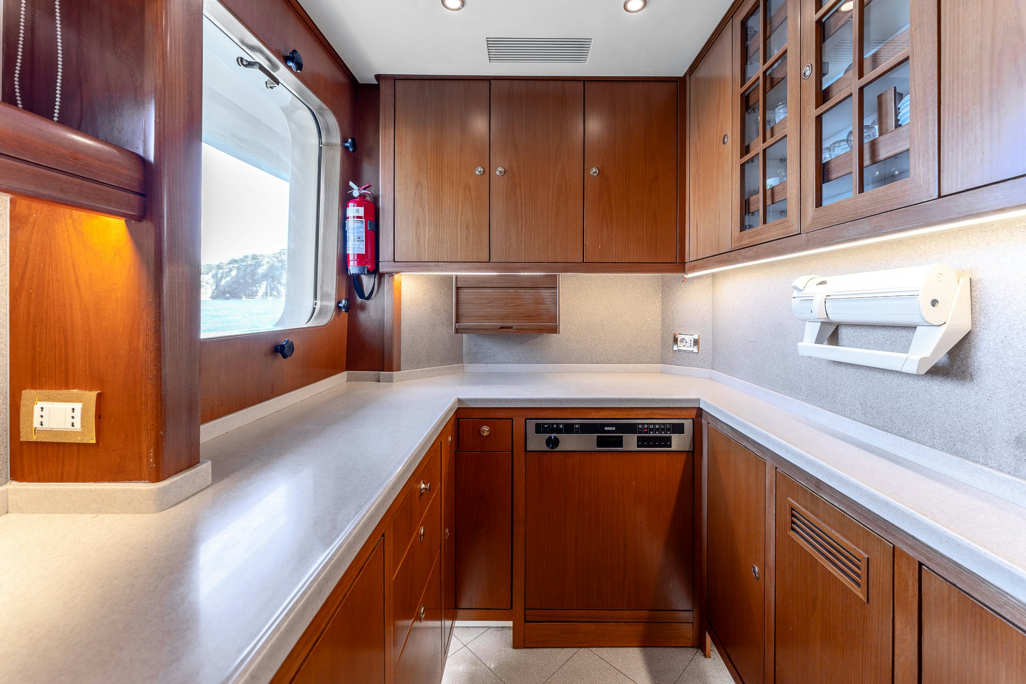 a kitchen with wooden cabinets aboard YOSMA Yacht for Sale