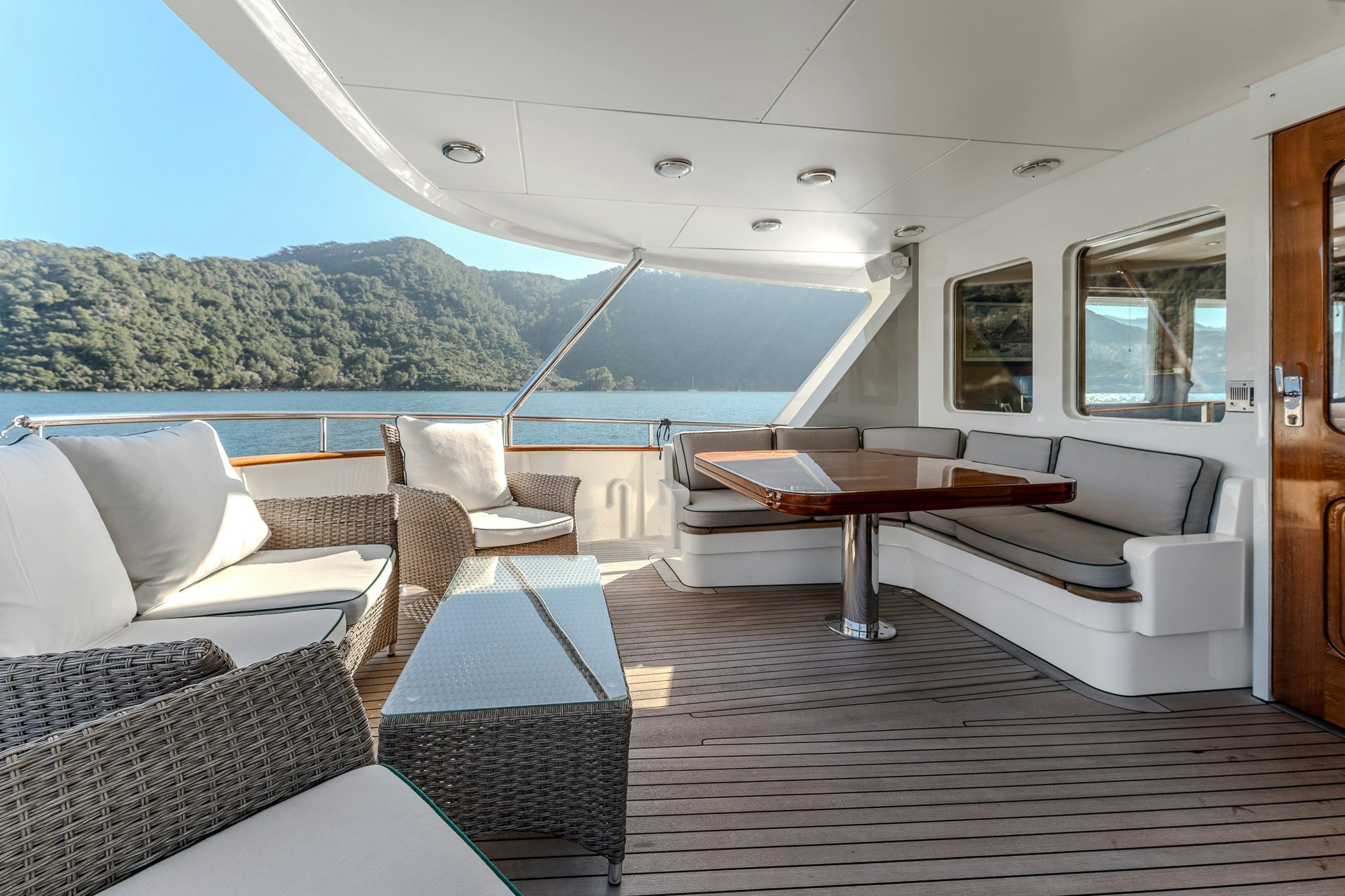 a living room with a table and chairs aboard YOSMA Yacht for Sale