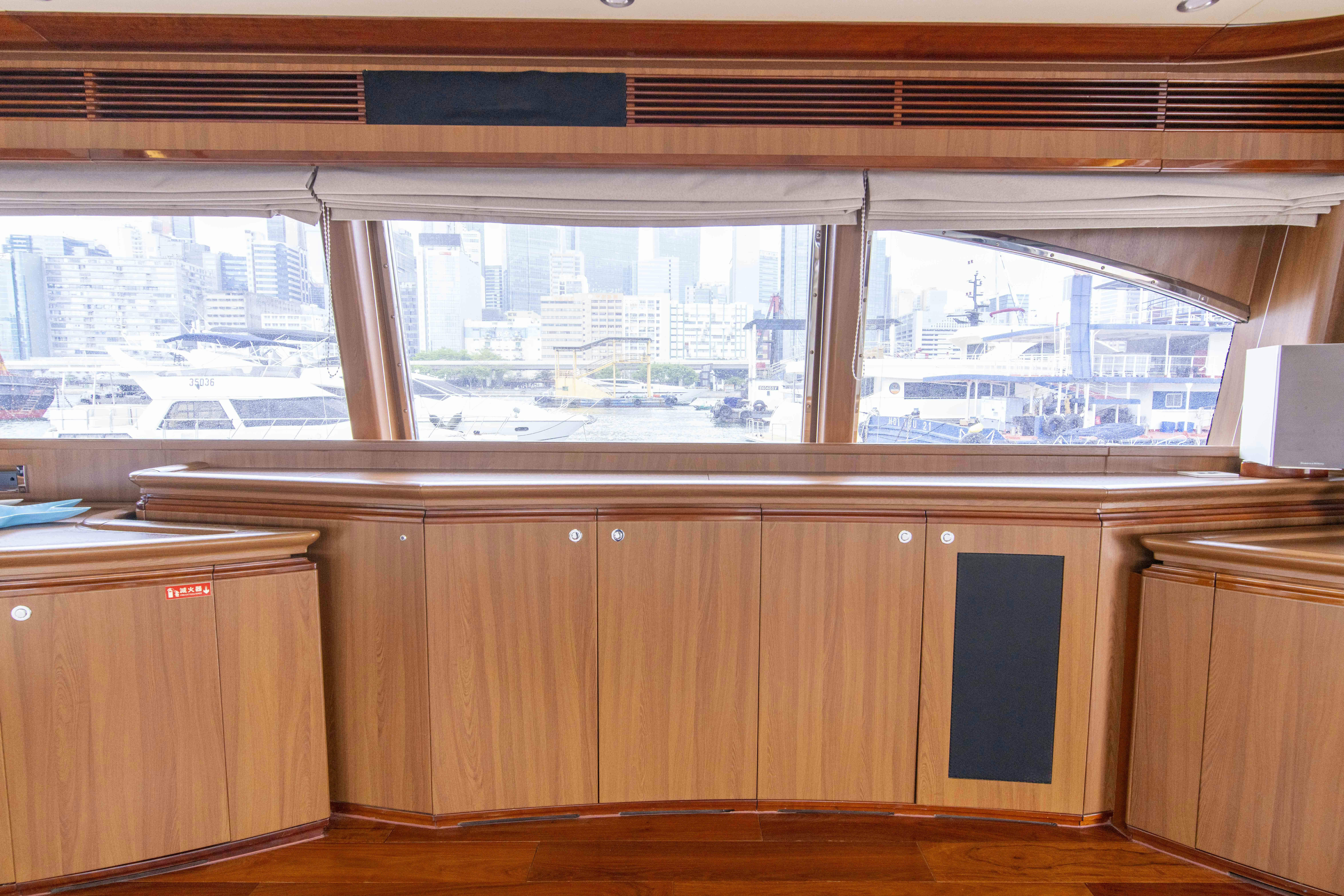 a room with wooden cabinets and a window aboard PANDORA Yacht for Sale
