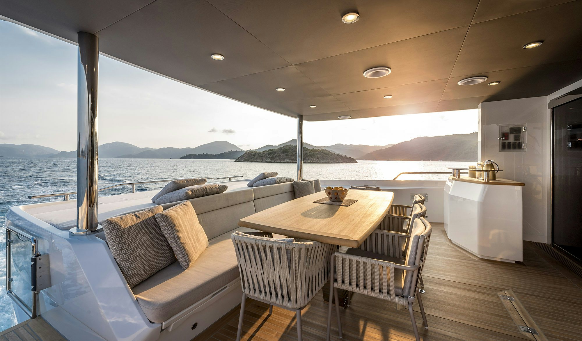 a large living room with a large balcony overlooking the ocean aboard MAORIA Yacht for Charter