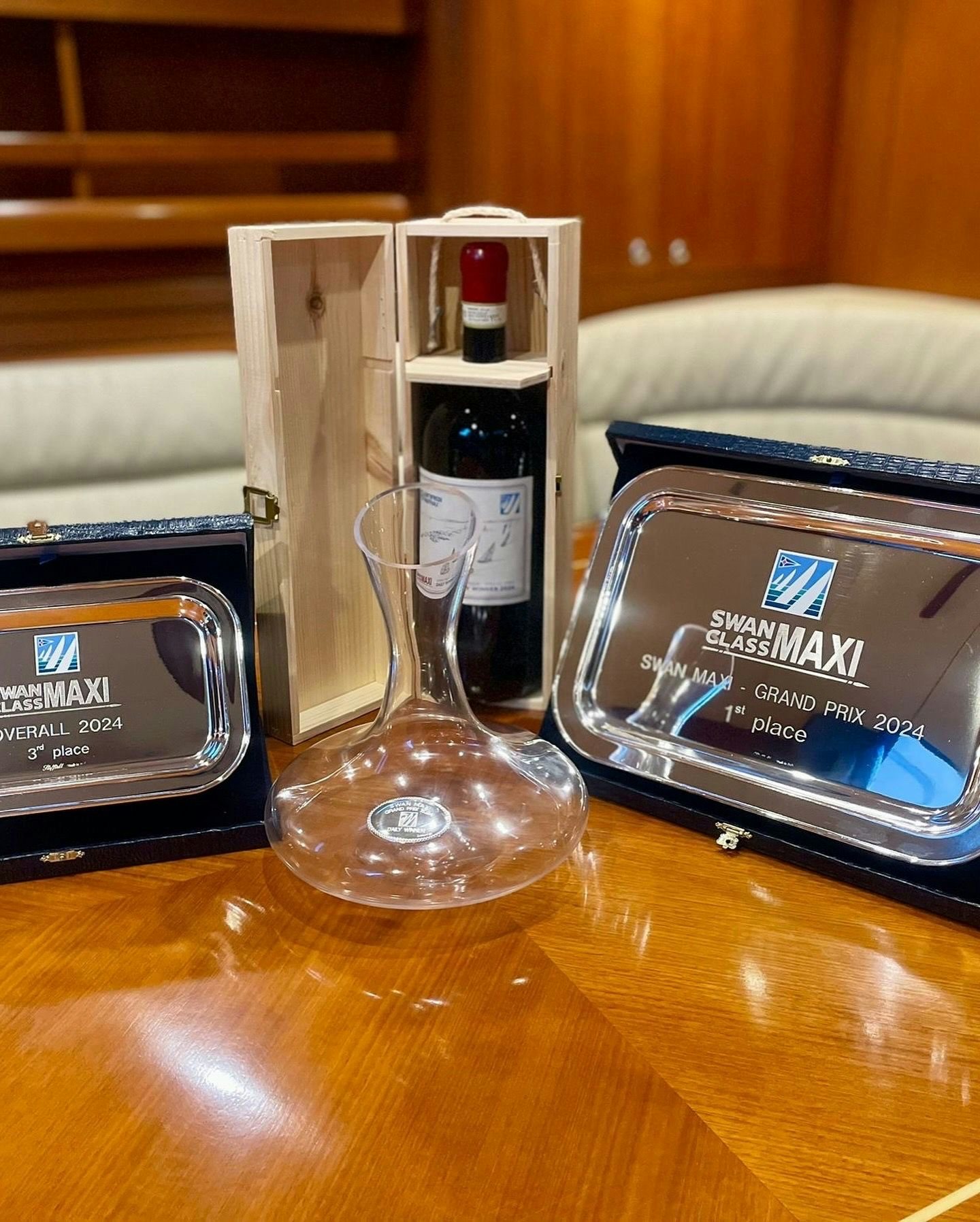 a bottle of perfume next to a phone and a box aboard UMIKO Yacht for Sale