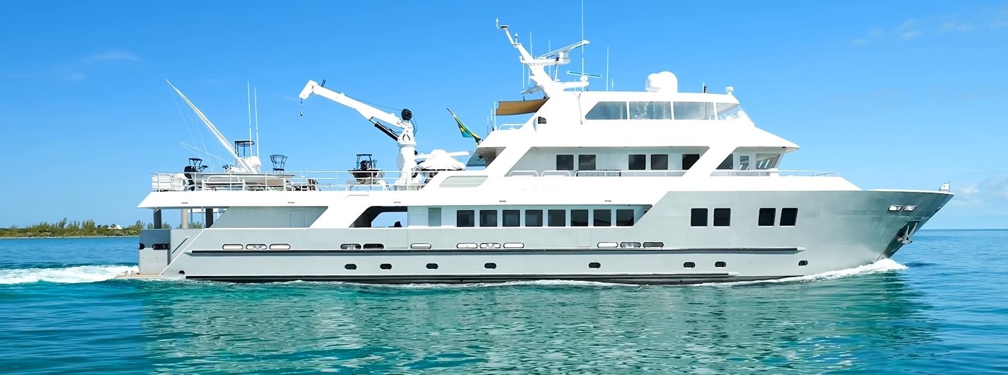 a large white boat with a drone flying over it aboard COMPASS ROSE Yacht for Sale