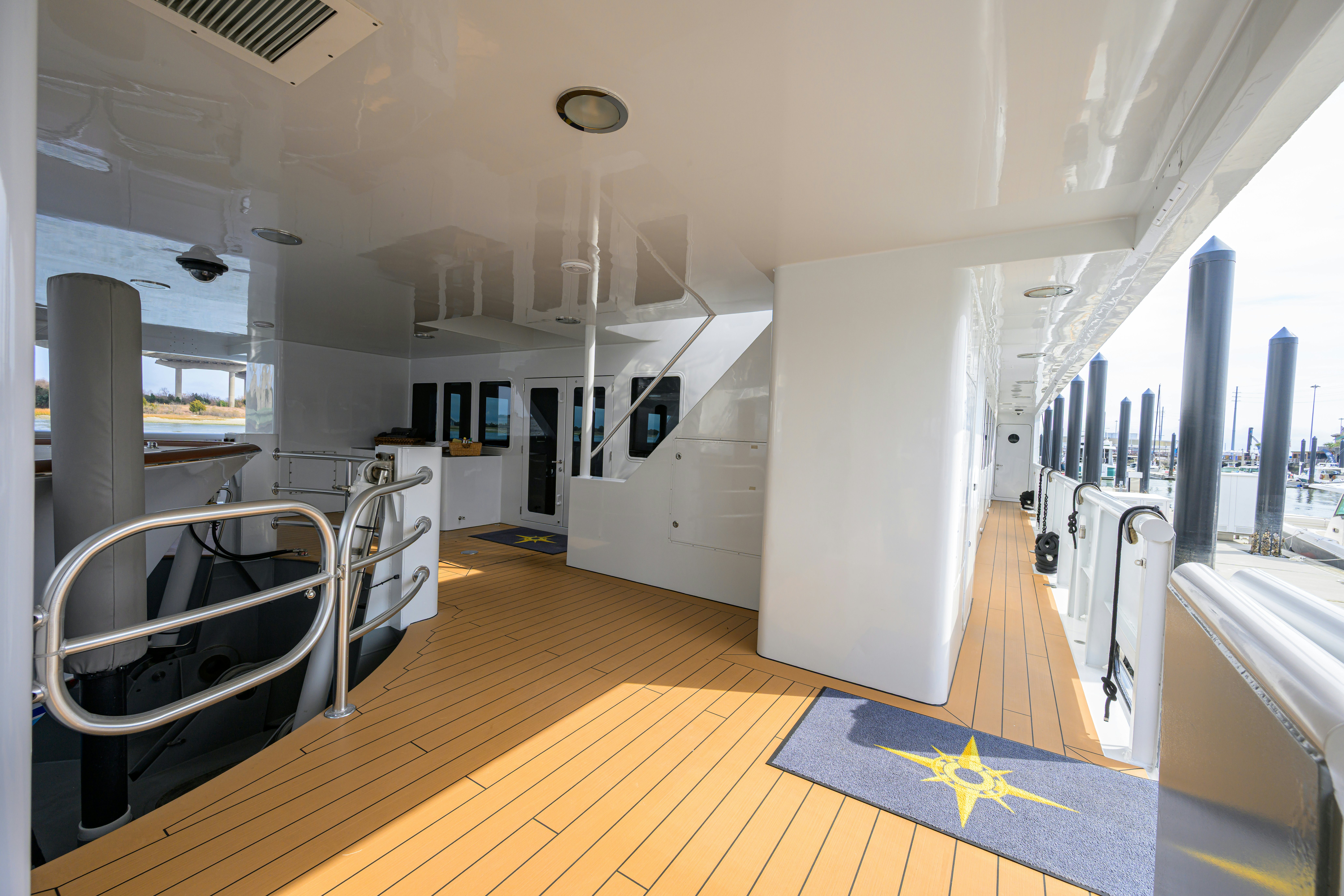 a room with white walls and a large window aboard COMPASS ROSE Yacht for Sale