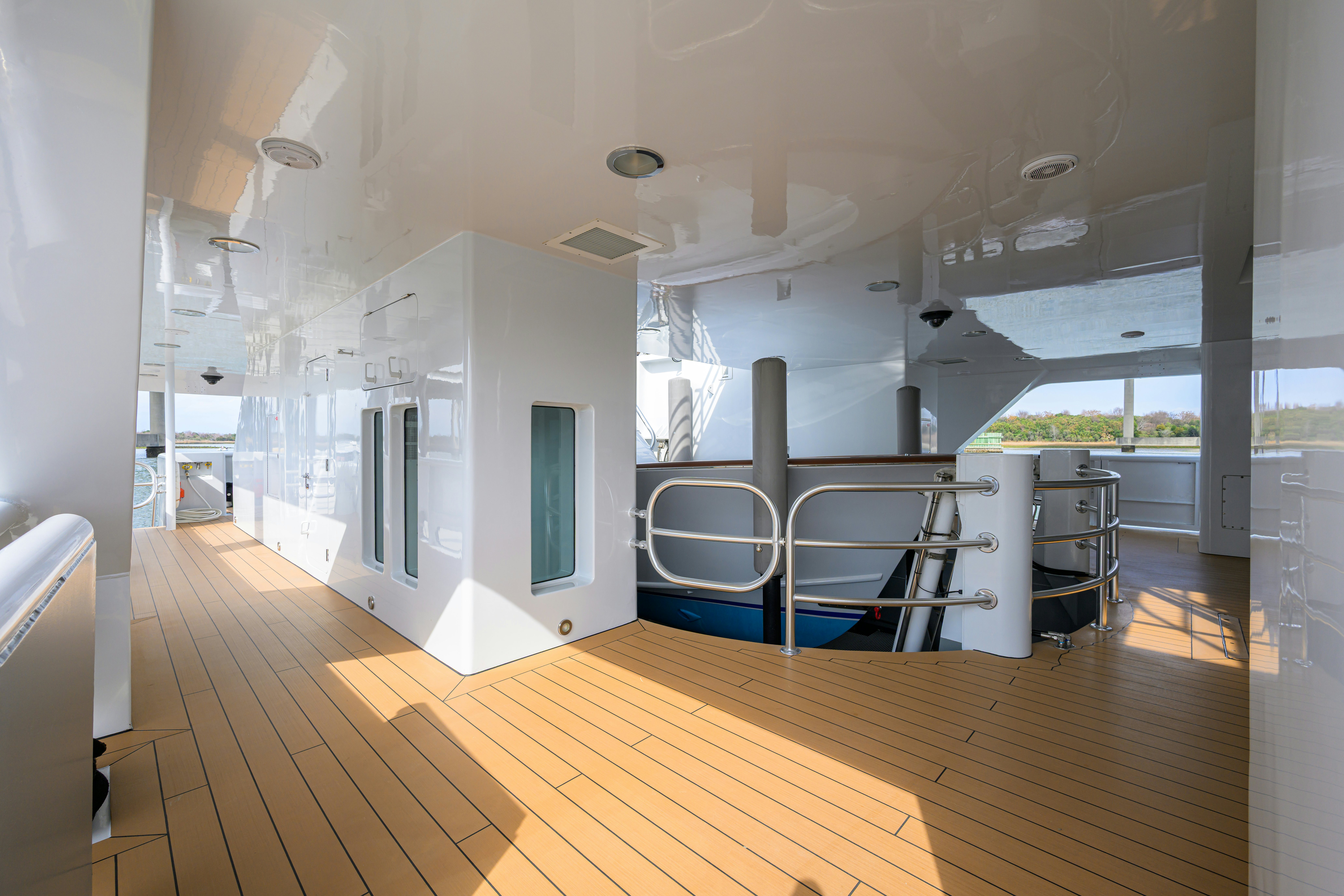 a room with a pool table and chairs aboard COMPASS ROSE Yacht for Sale