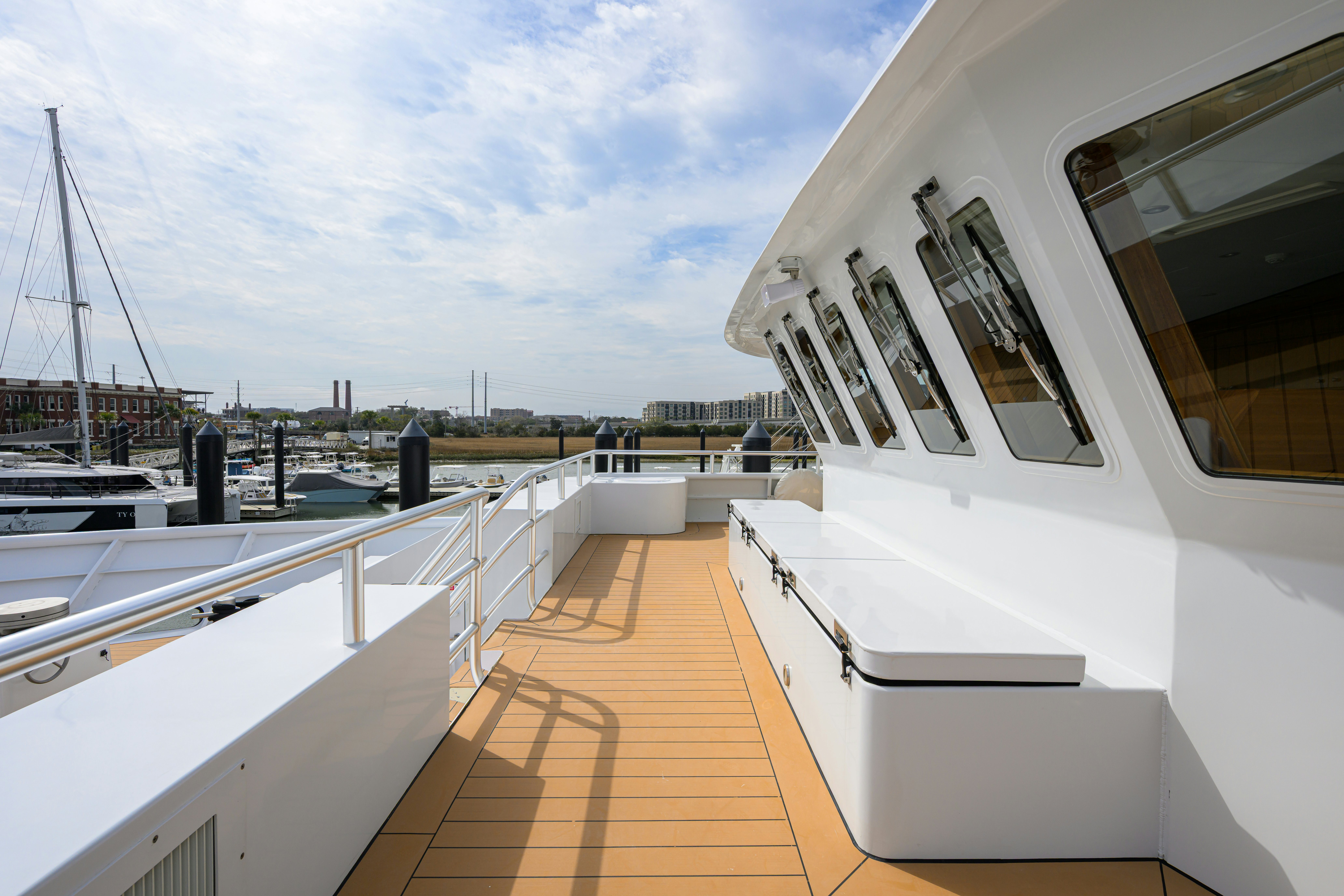 a deck with a deck and a boat on it aboard COMPASS ROSE Yacht for Sale