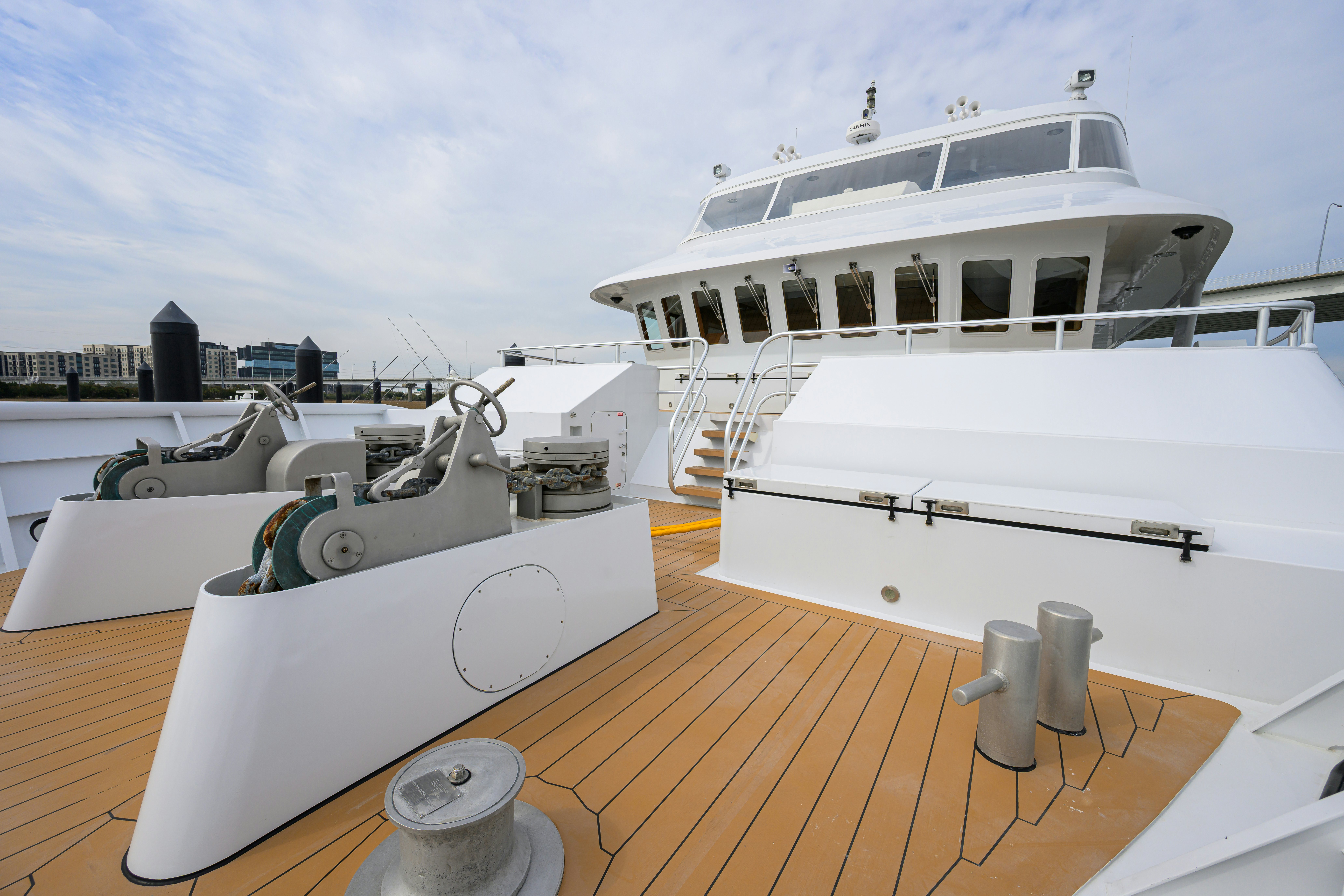 a deck with a large yacht aboard COMPASS ROSE Yacht for Sale