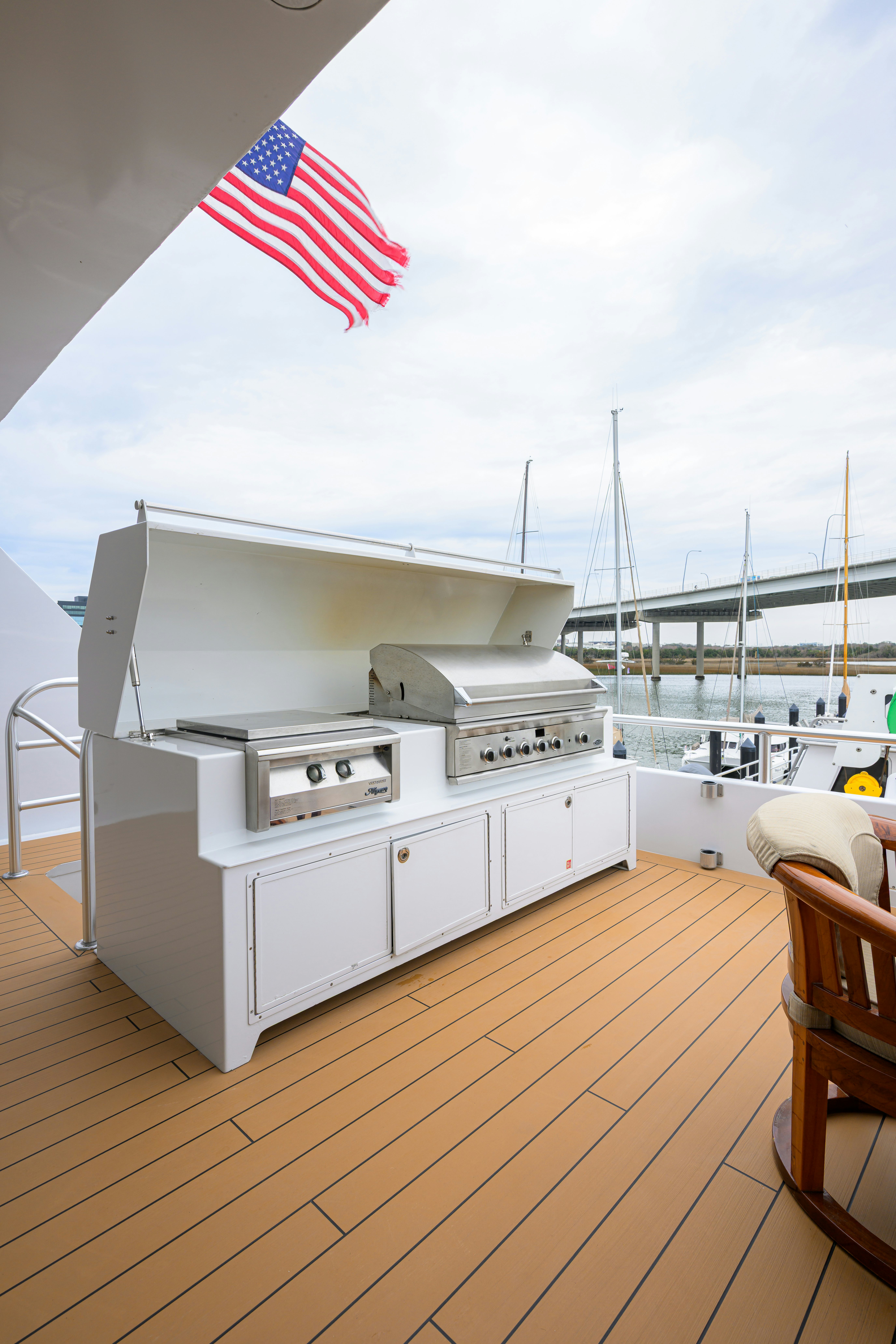 a large white kitchen with a flag aboard COMPASS ROSE Yacht for Sale