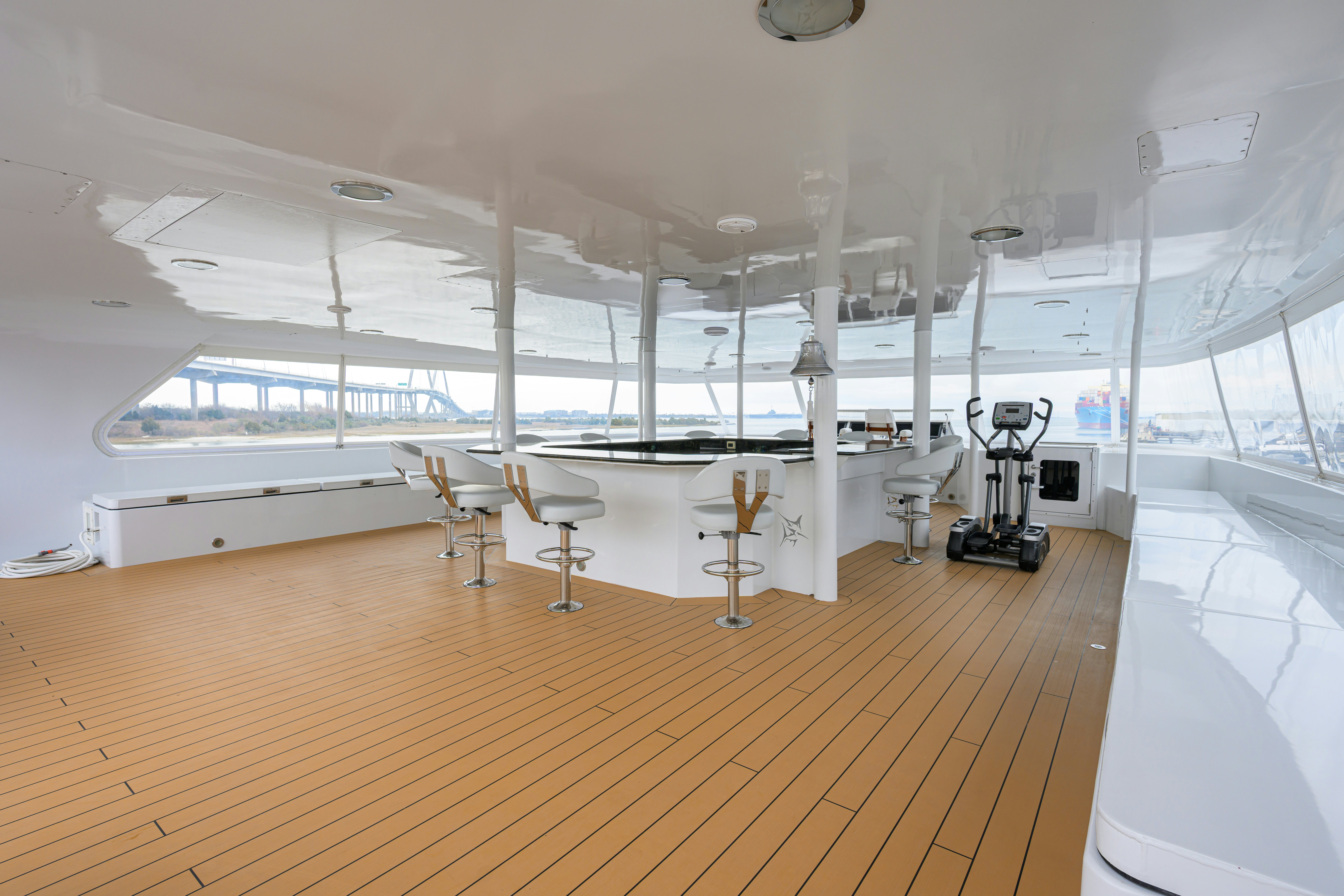 a room with tables and chairs aboard COMPASS ROSE Yacht for Sale