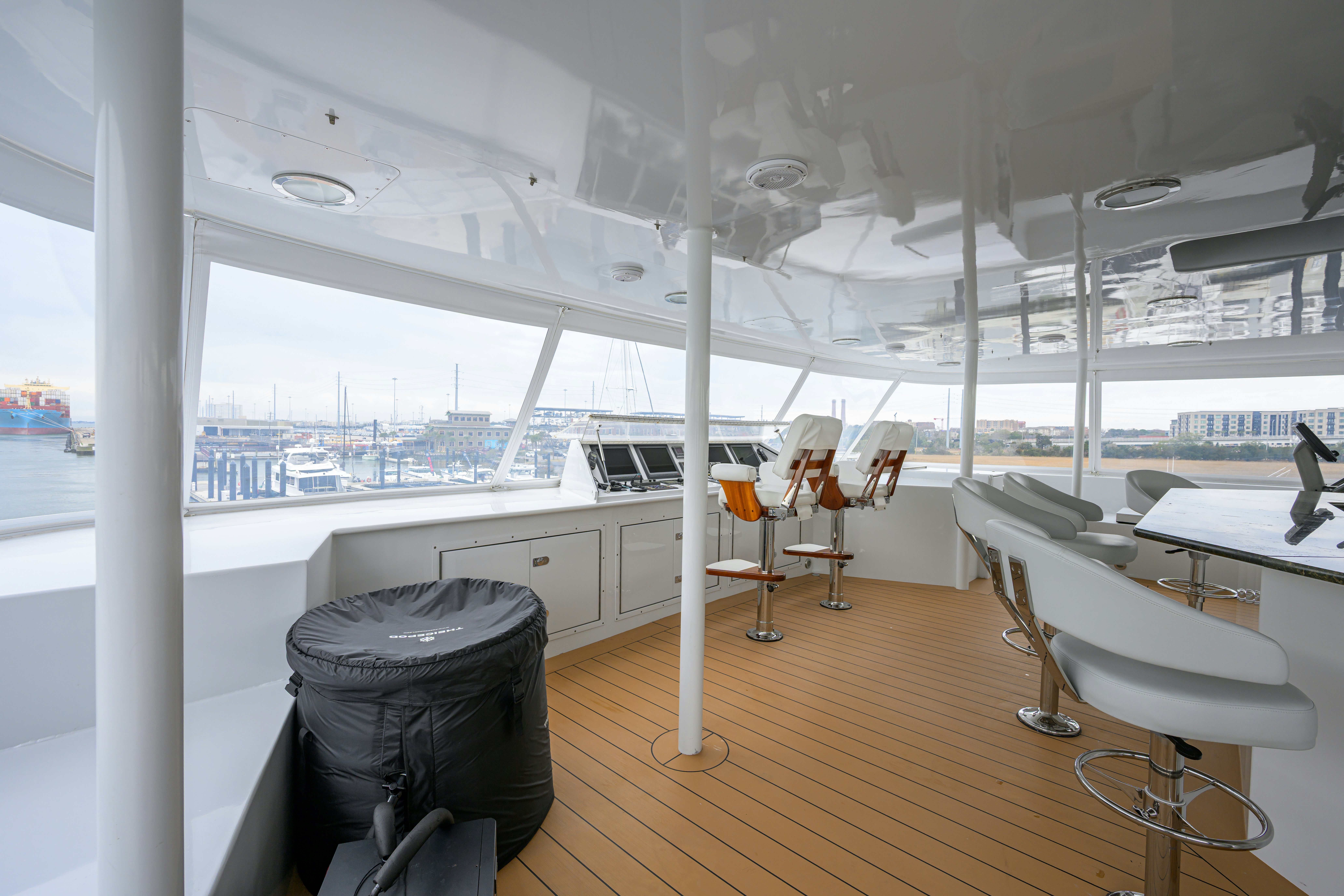 a room with tables and chairs aboard COMPASS ROSE Yacht for Sale