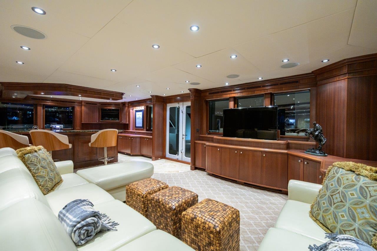 a living room with a large tv aboard COMPASS ROSE Yacht for Sale