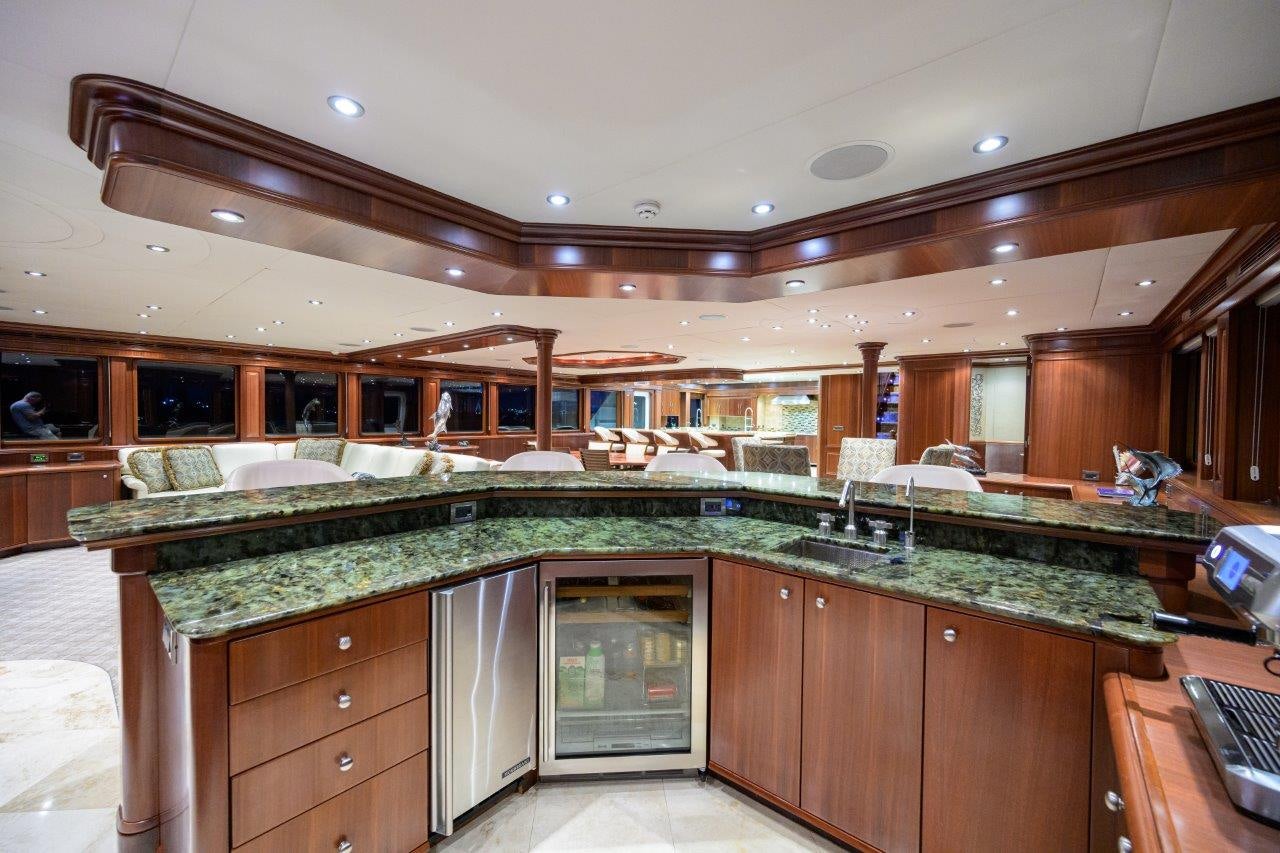 a large kitchen with a bar and countertop aboard COMPASS ROSE Yacht for Sale