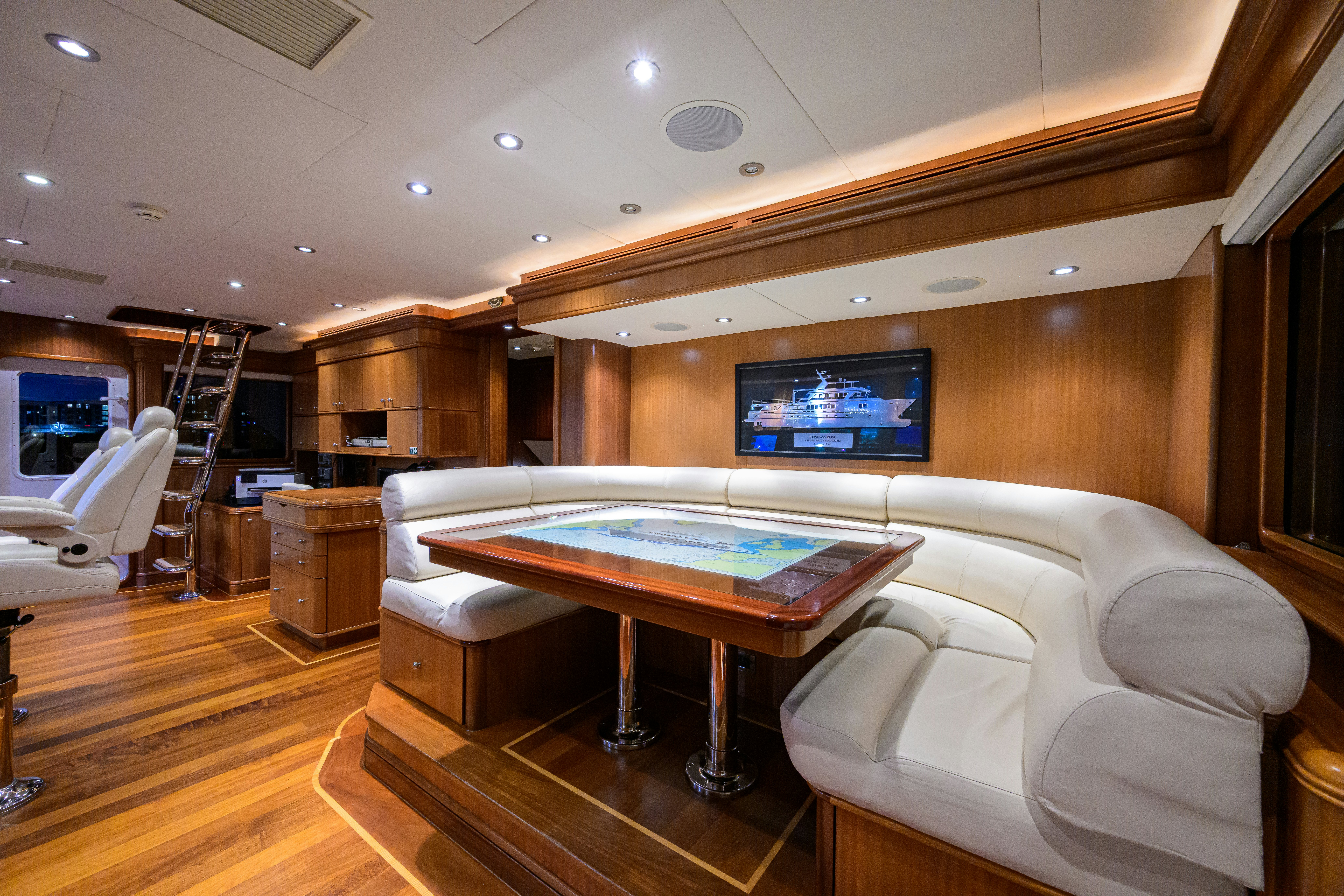 a room with a pool table and couches aboard COMPASS ROSE Yacht for Sale