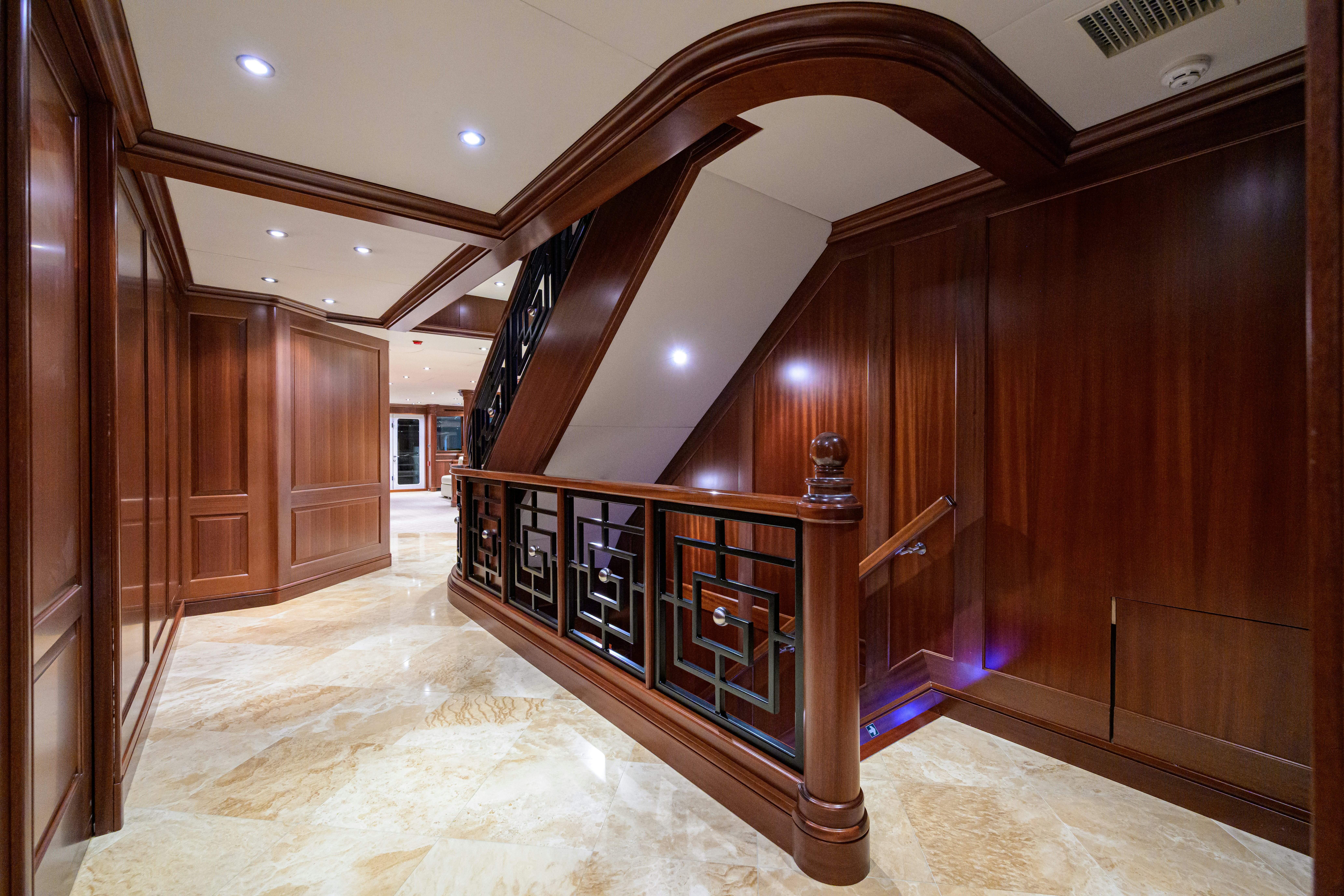 a large wooden staircase in a building aboard COMPASS ROSE Yacht for Sale