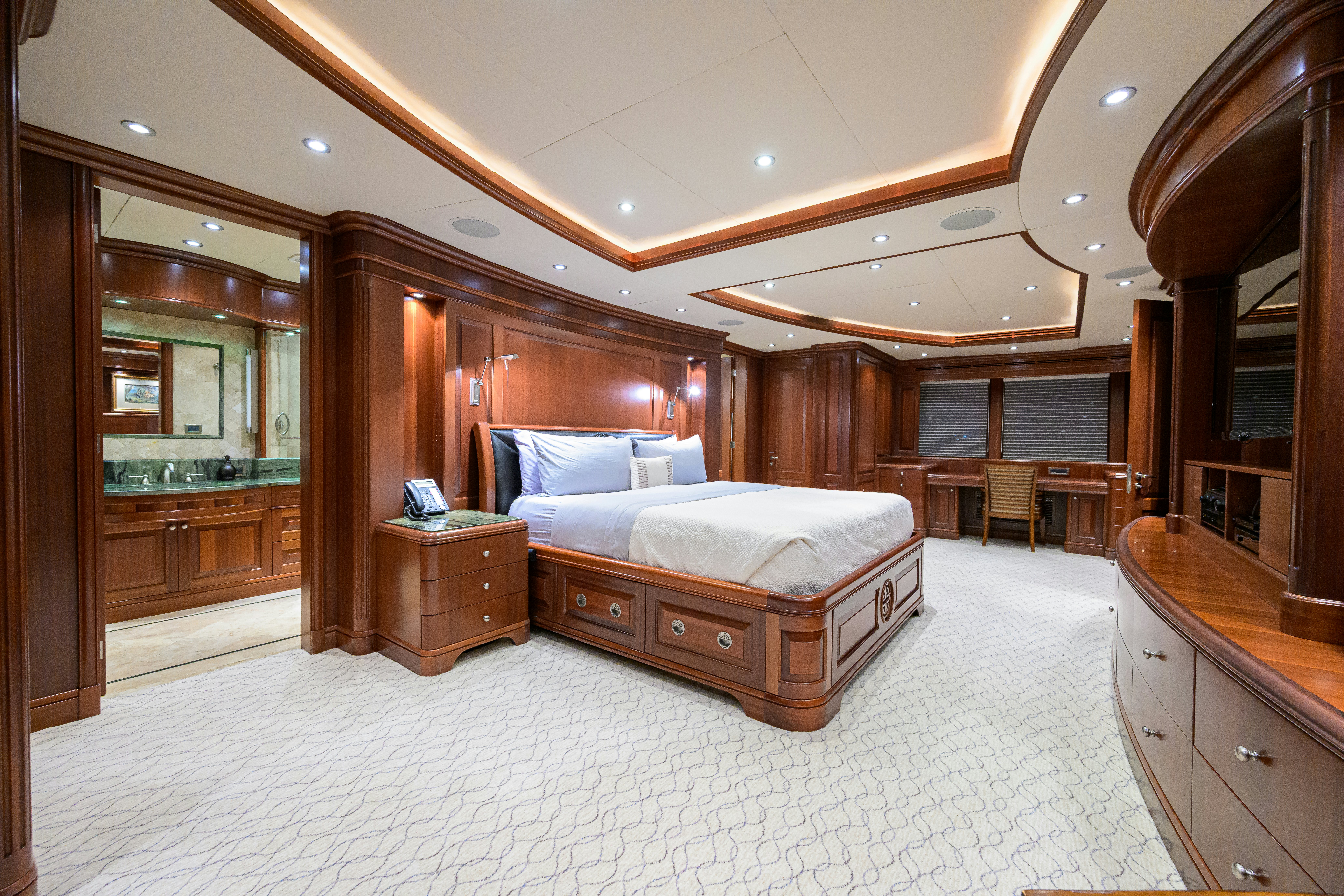 a large bedroom with a bed aboard COMPASS ROSE Yacht for Sale