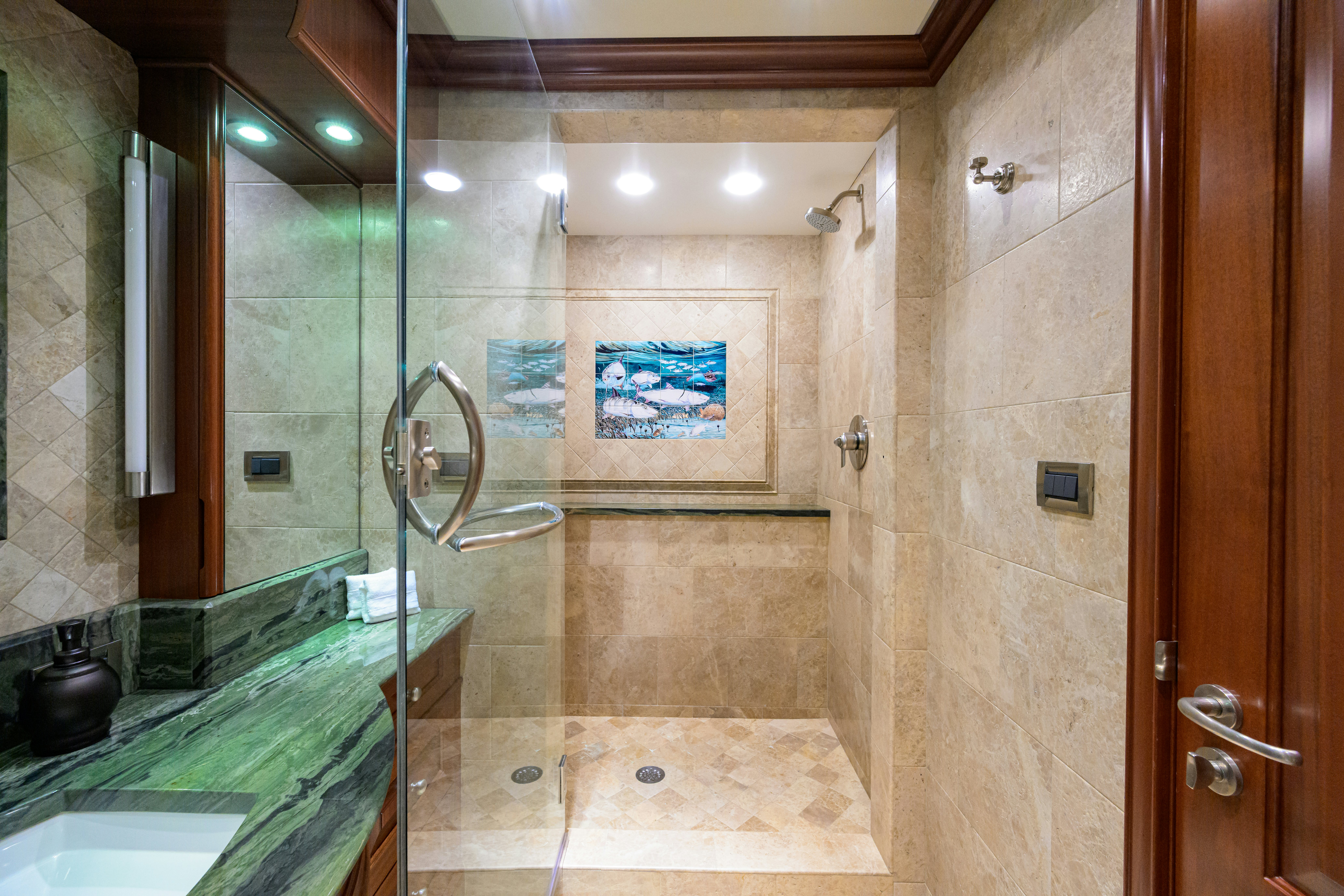 a bathroom with a glass shower aboard COMPASS ROSE Yacht for Sale