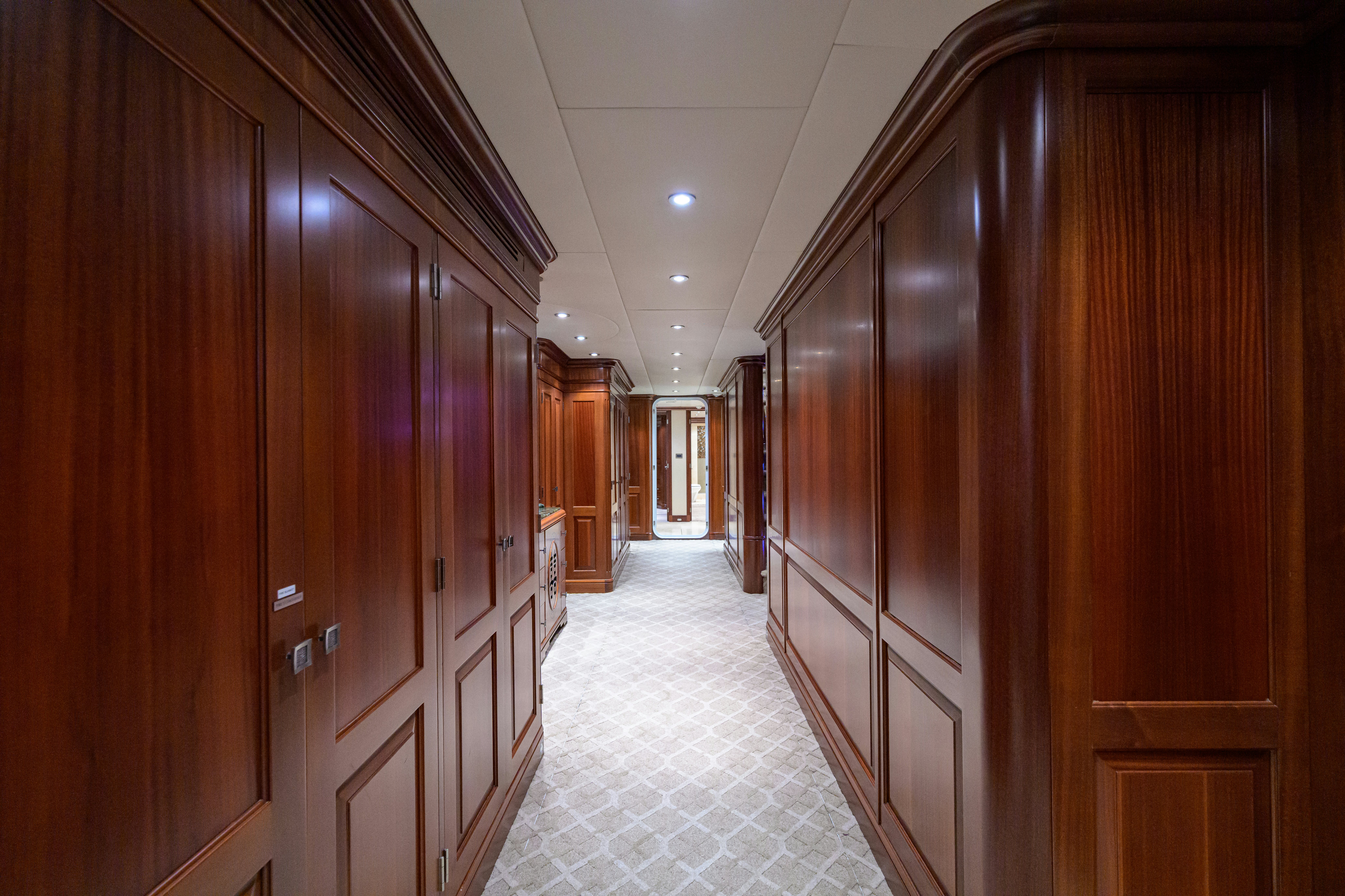 a hallway with wooden cabinets aboard COMPASS ROSE Yacht for Sale