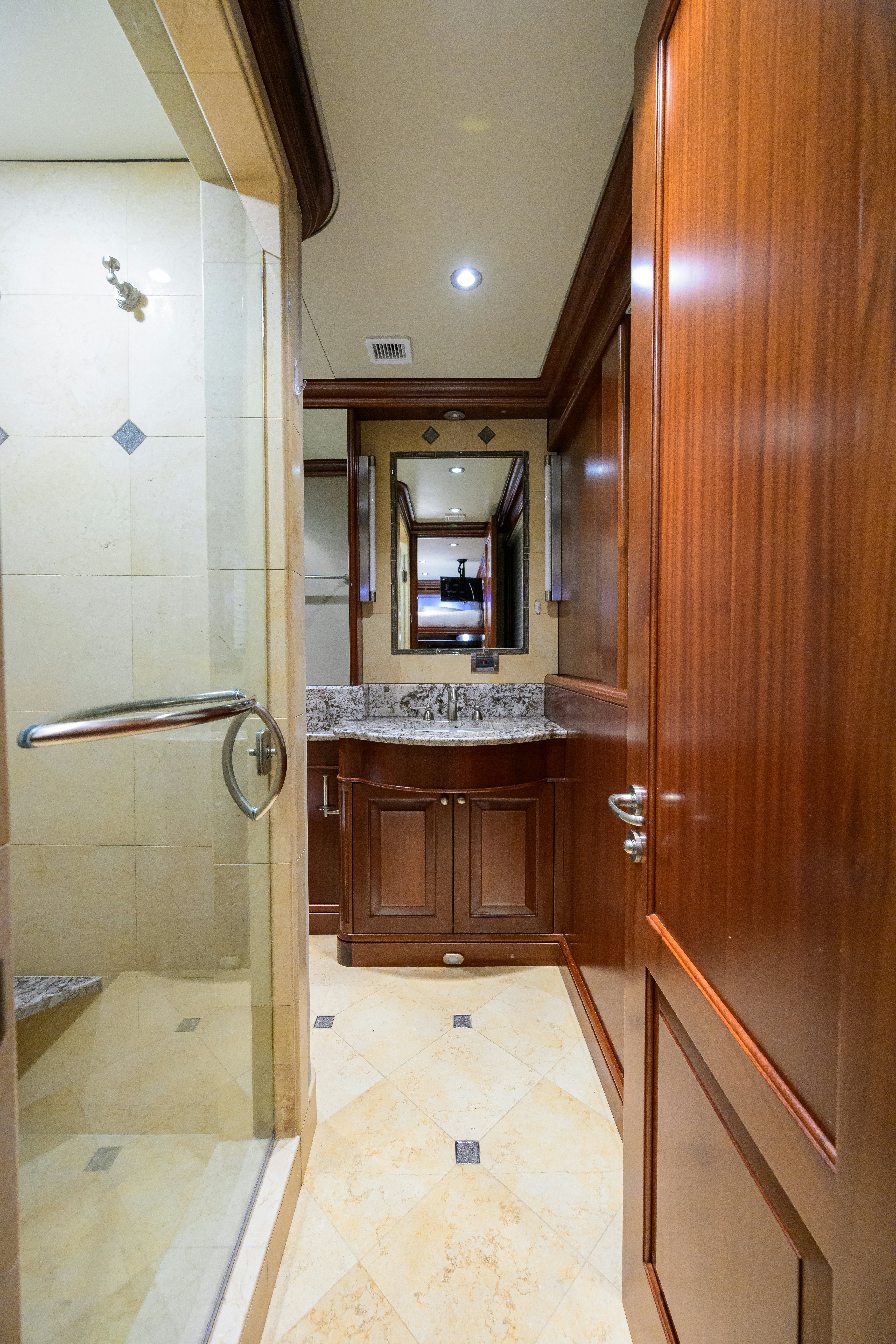 a bathroom with a mirror and a sink aboard COMPASS ROSE Yacht for Sale