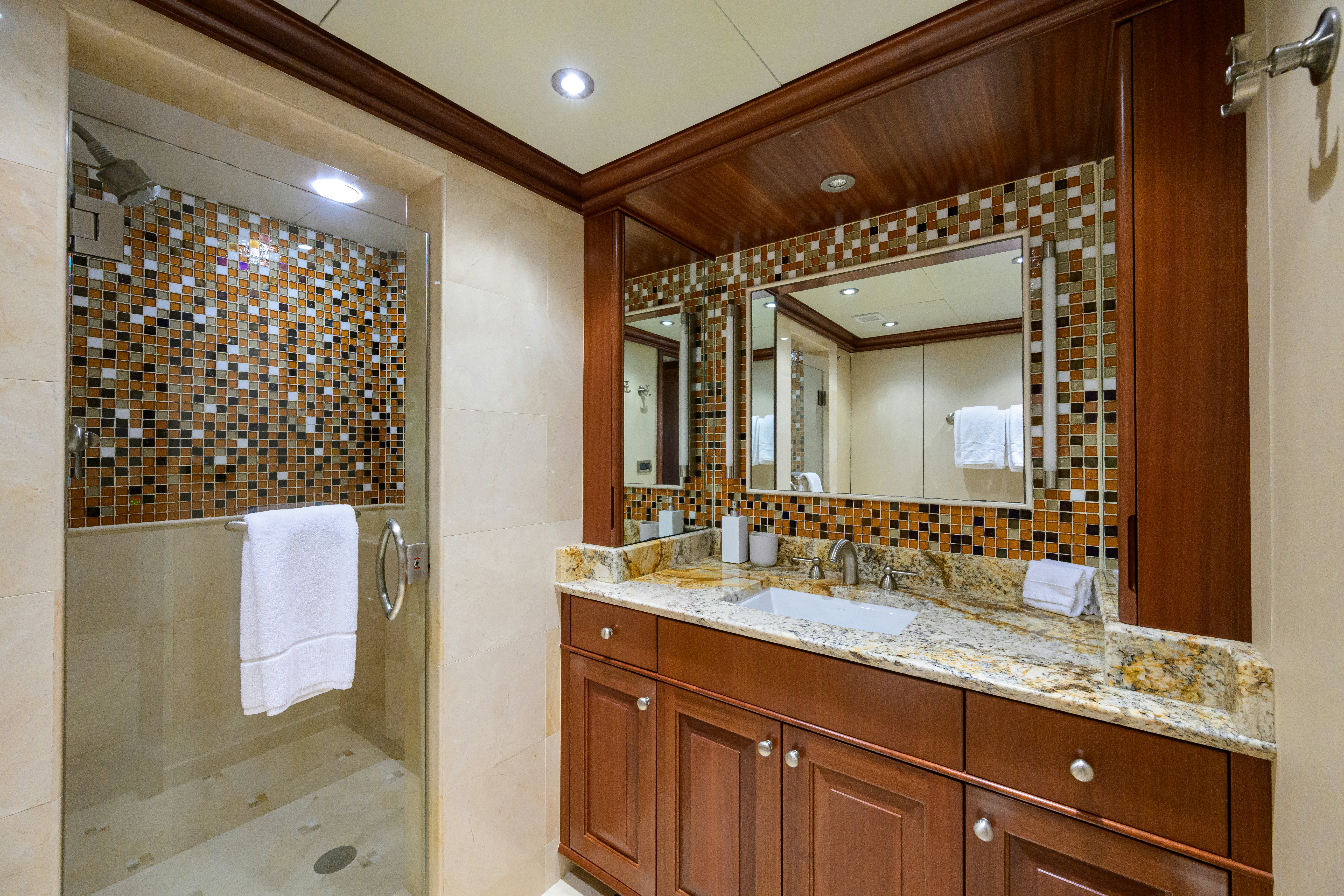 a bathroom with a large mirror aboard COMPASS ROSE Yacht for Sale