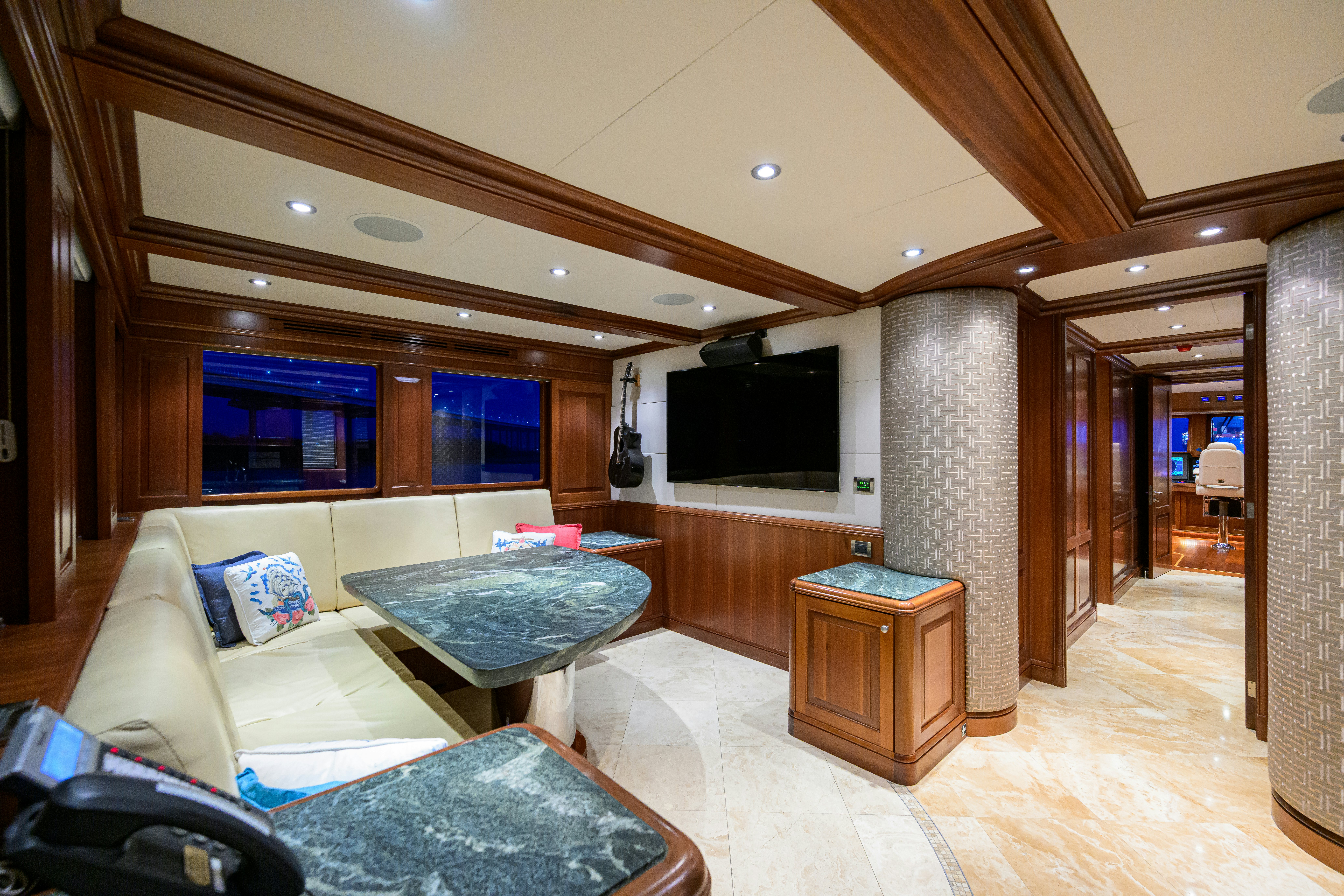 a living room with a fireplace aboard COMPASS ROSE Yacht for Sale