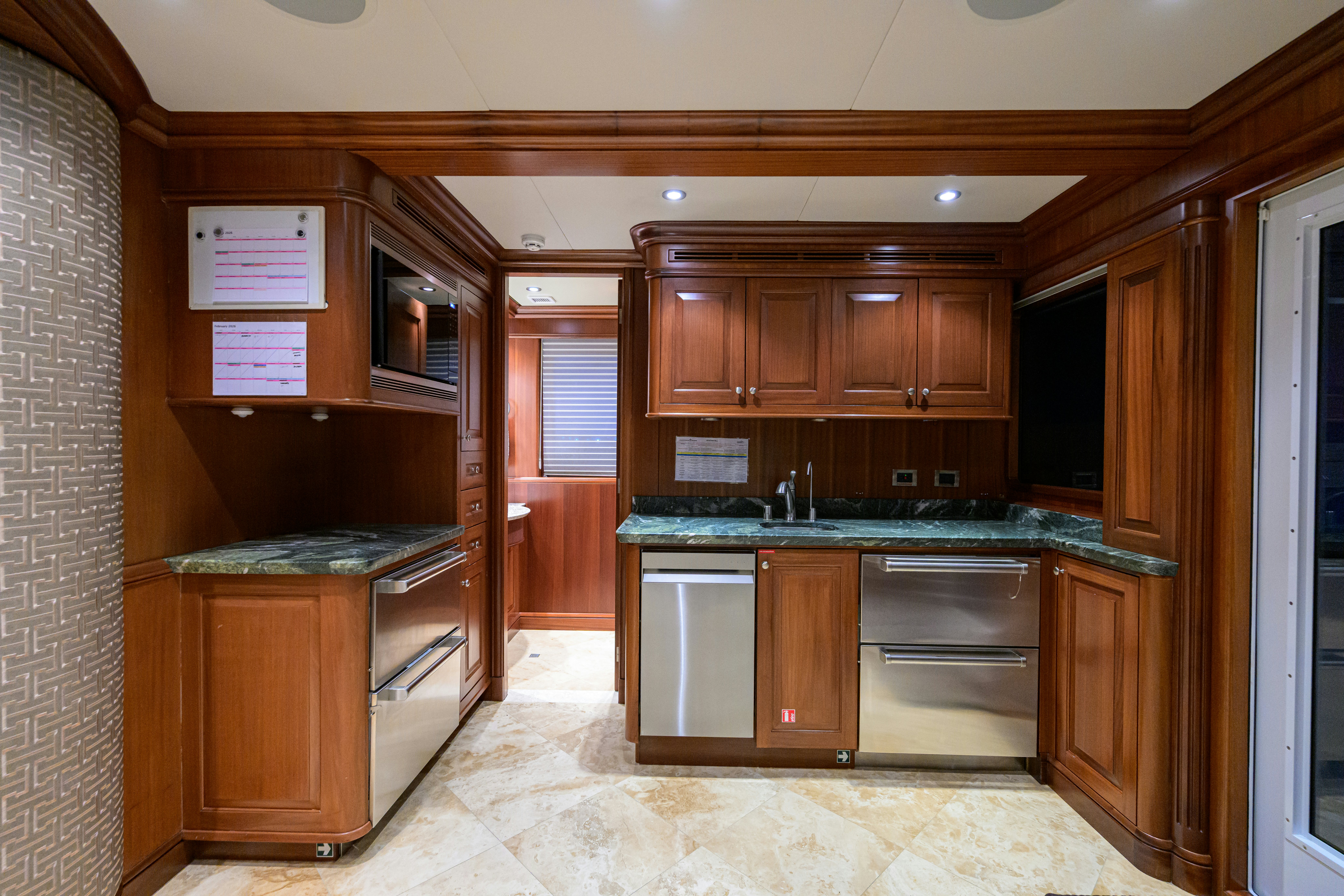 a kitchen with wooden cabinets aboard COMPASS ROSE Yacht for Sale