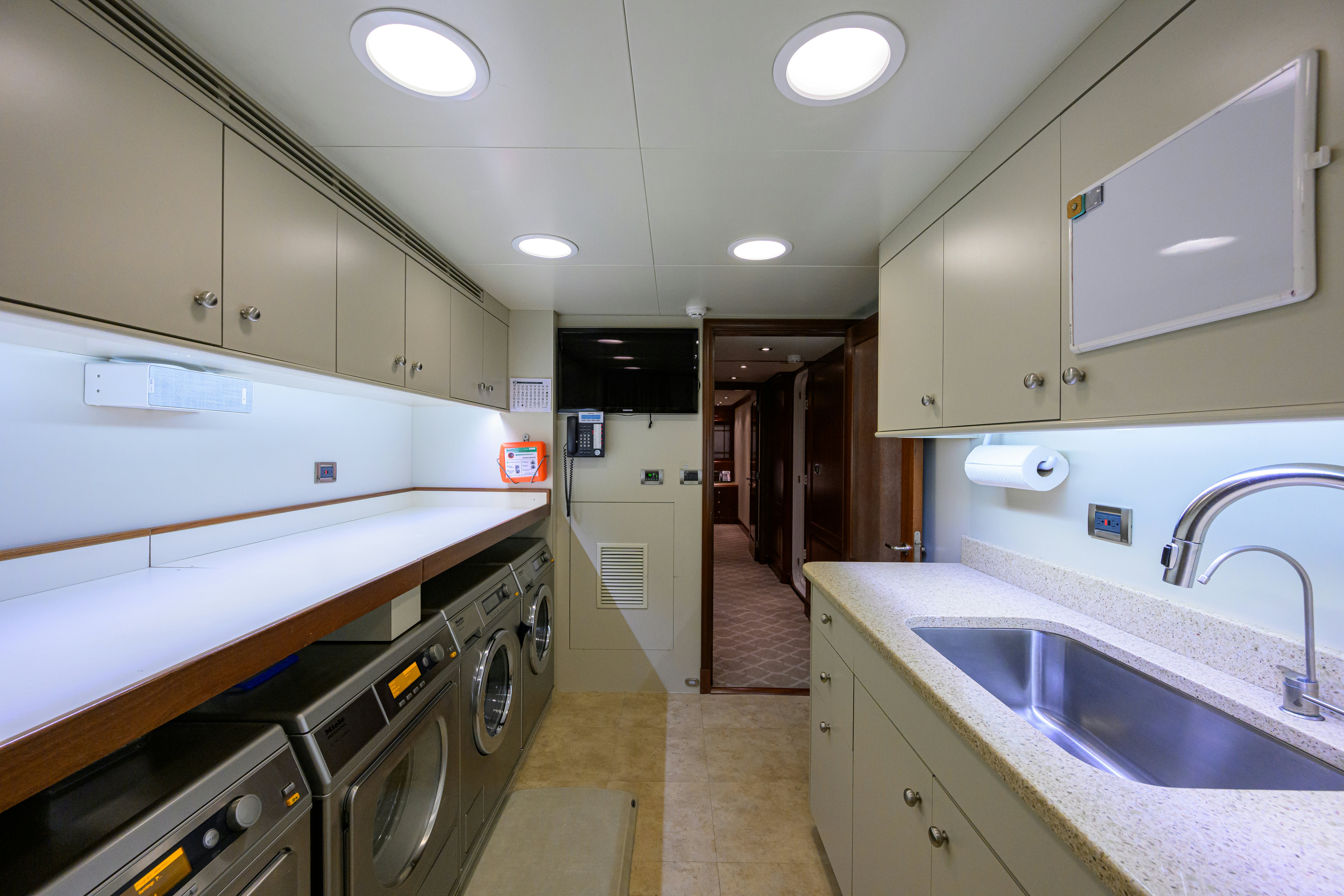 a kitchen with a sink and a microwave aboard COMPASS ROSE Yacht for Sale