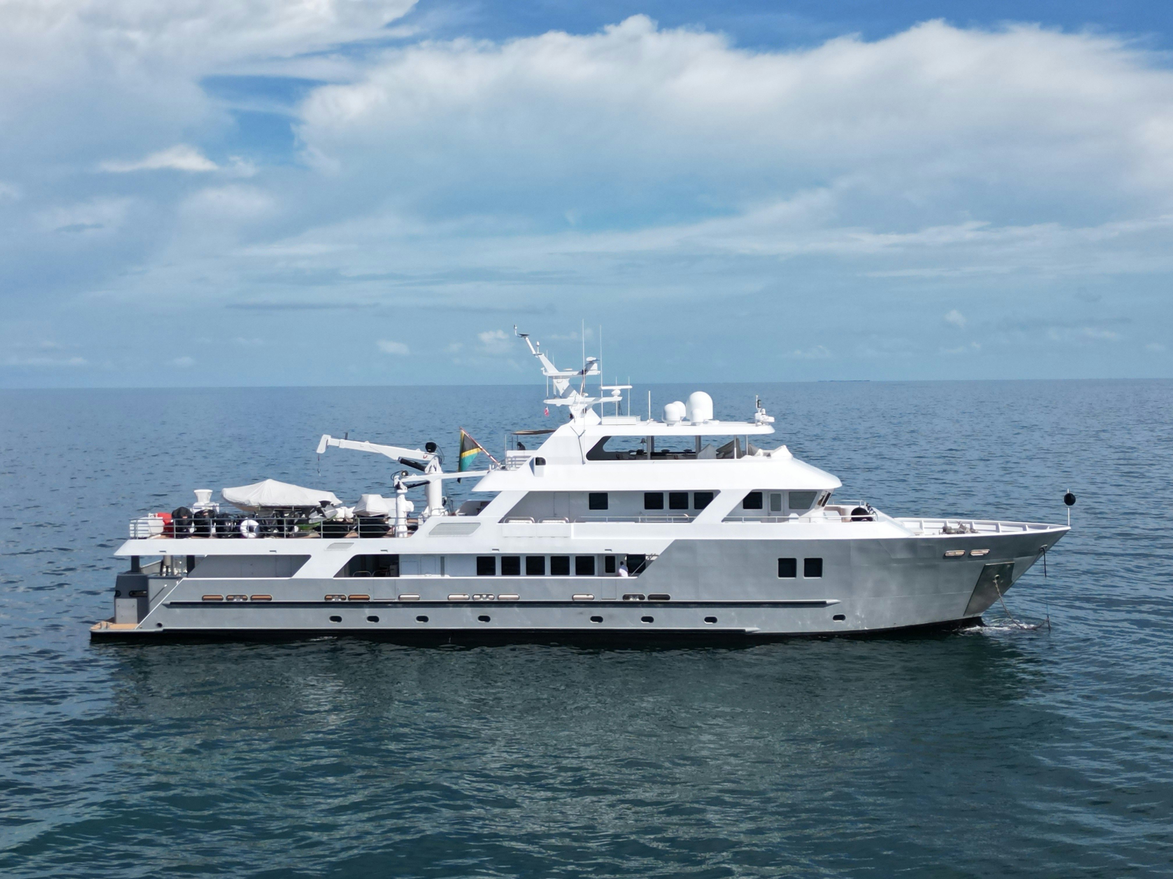 a large white yacht in the water aboard COMPASS ROSE Yacht for Sale
