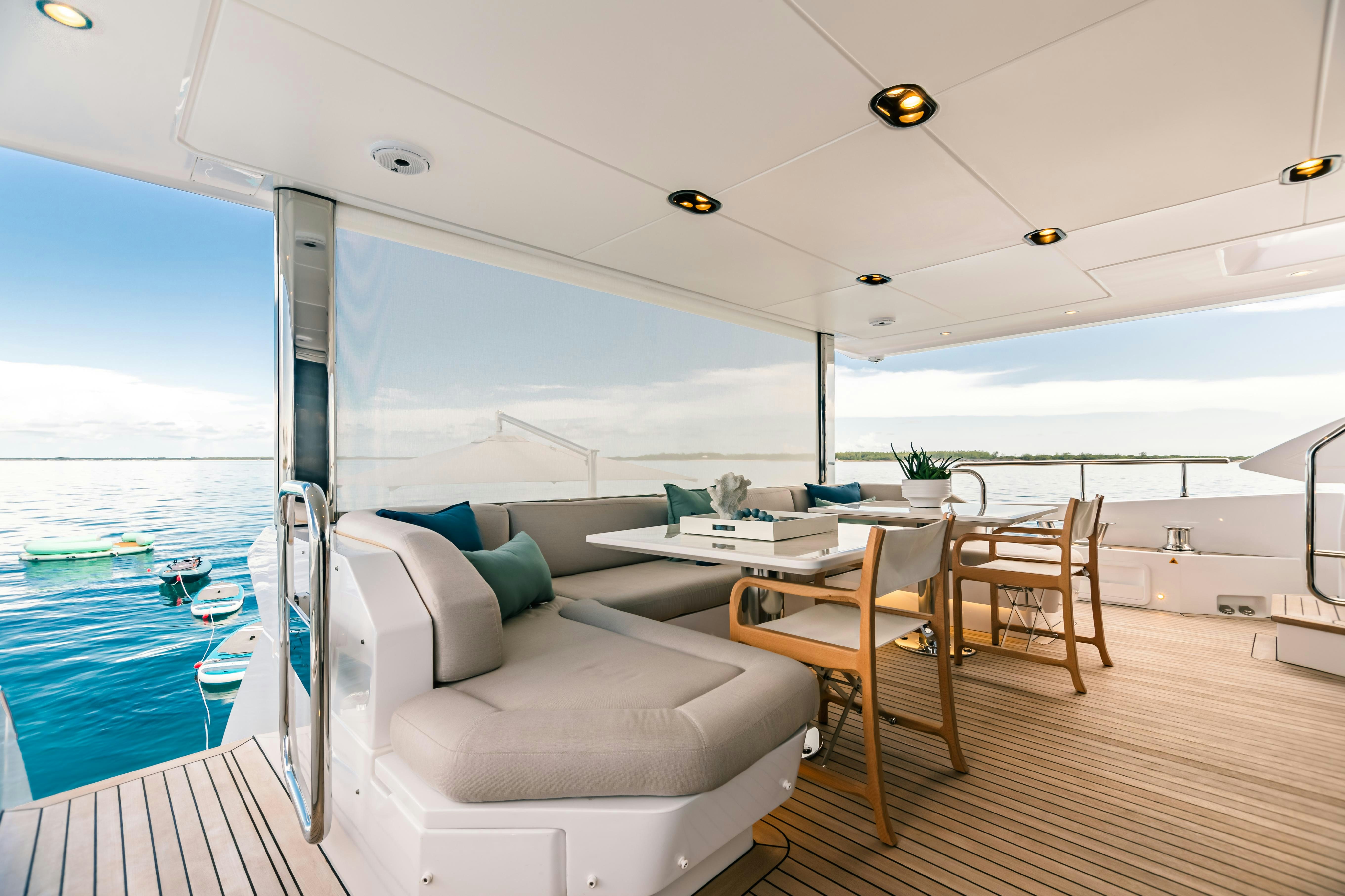 a room with a couch and a table and a large body of water aboard MAREA LA NAUTICA Yacht for Charter