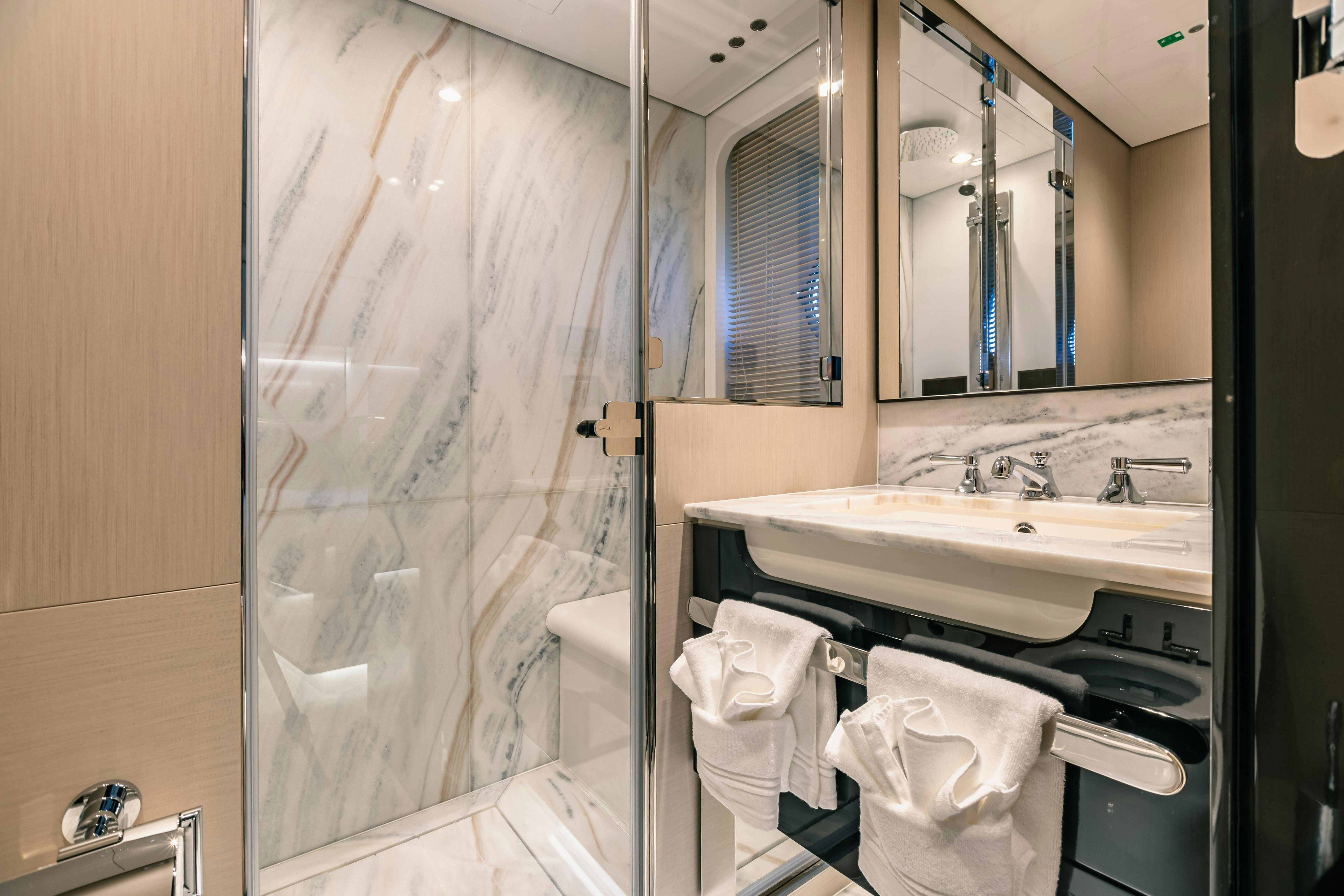 a bathroom with a glass shower aboard MAREA LA NAUTICA Yacht for Charter