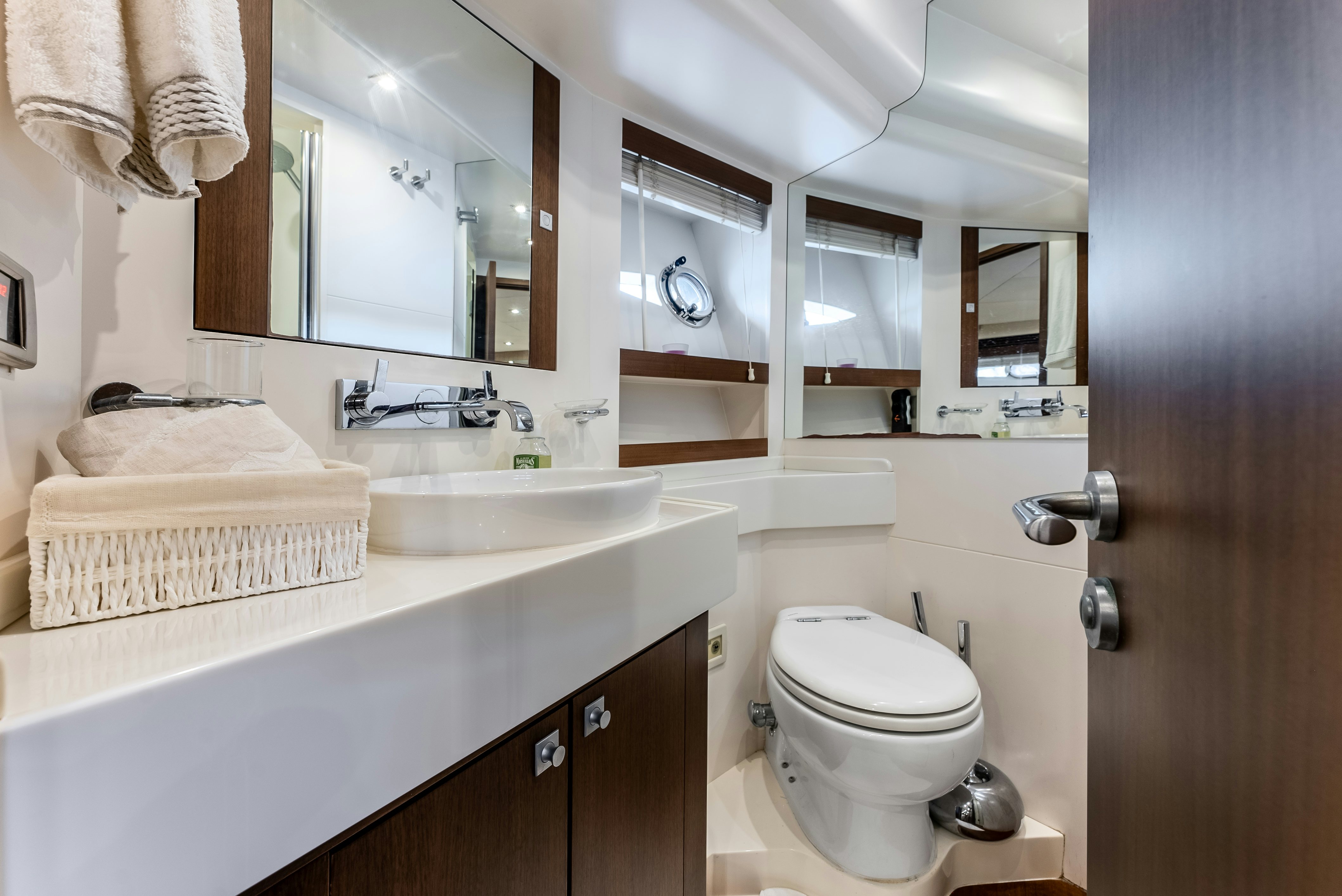 a bathroom with a sink toilet and a mirror aboard LADY F Yacht for Sale