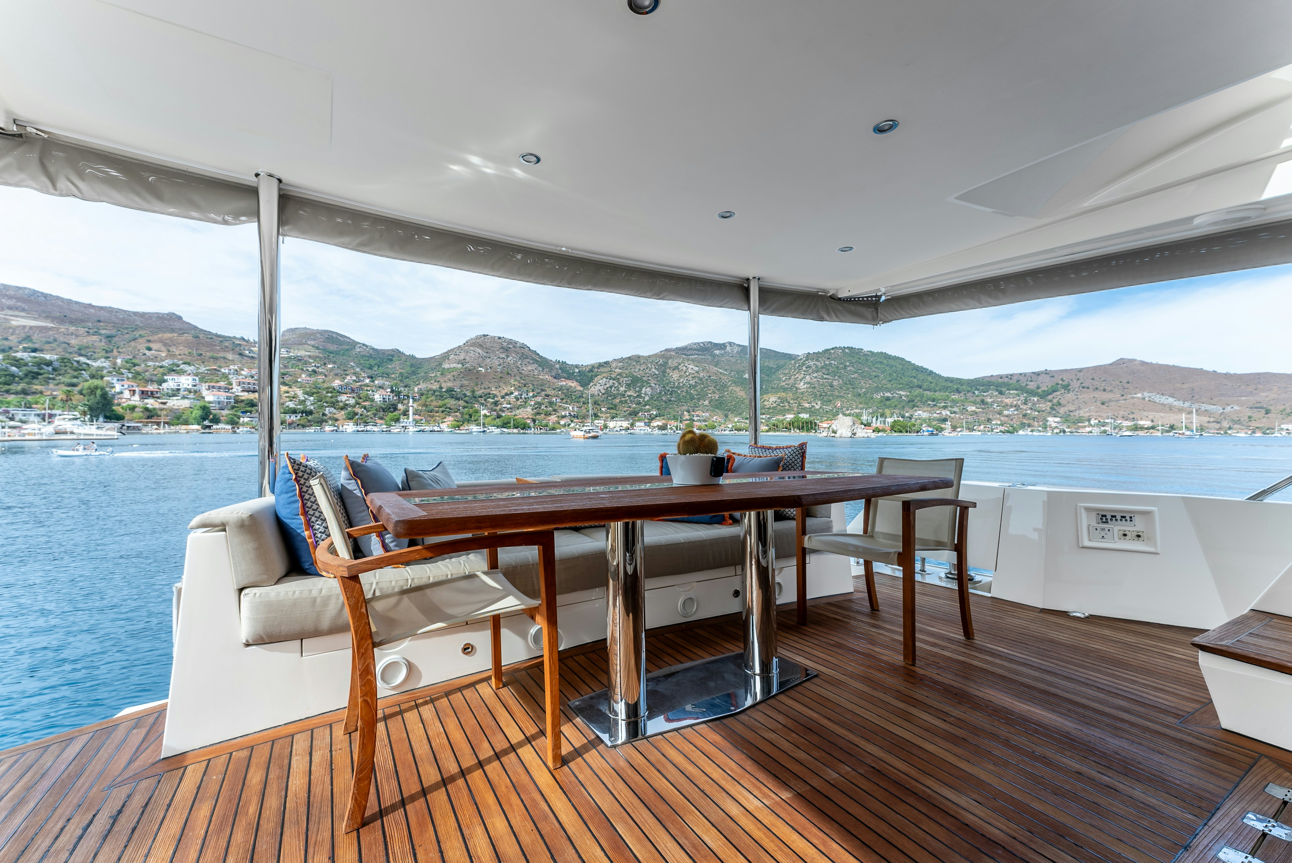 a deck with a table and chairs on it aboard LADY F Yacht for Sale